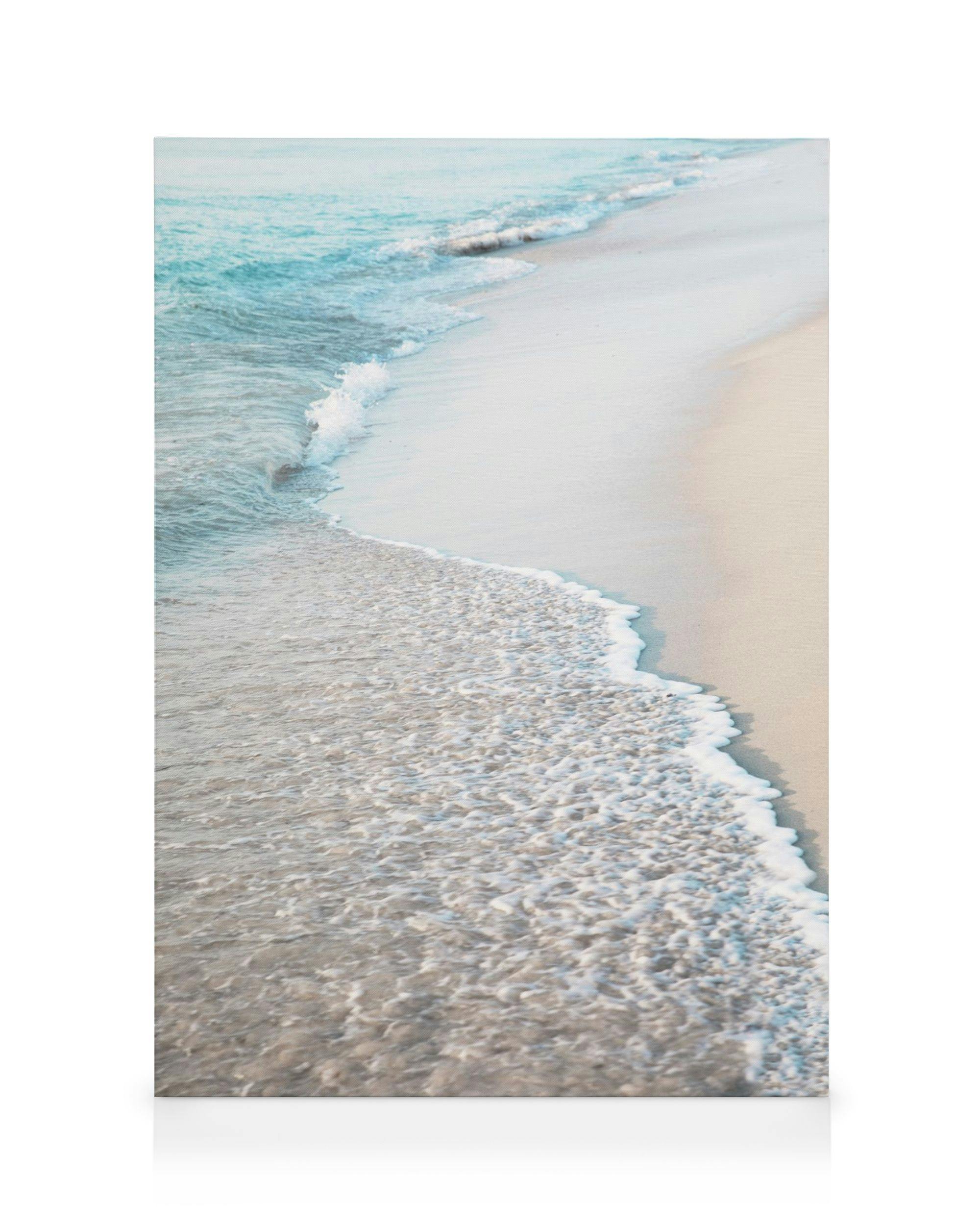 Blue beach wave canvas print showing light blue ocean waves breaking on a sandy shore.