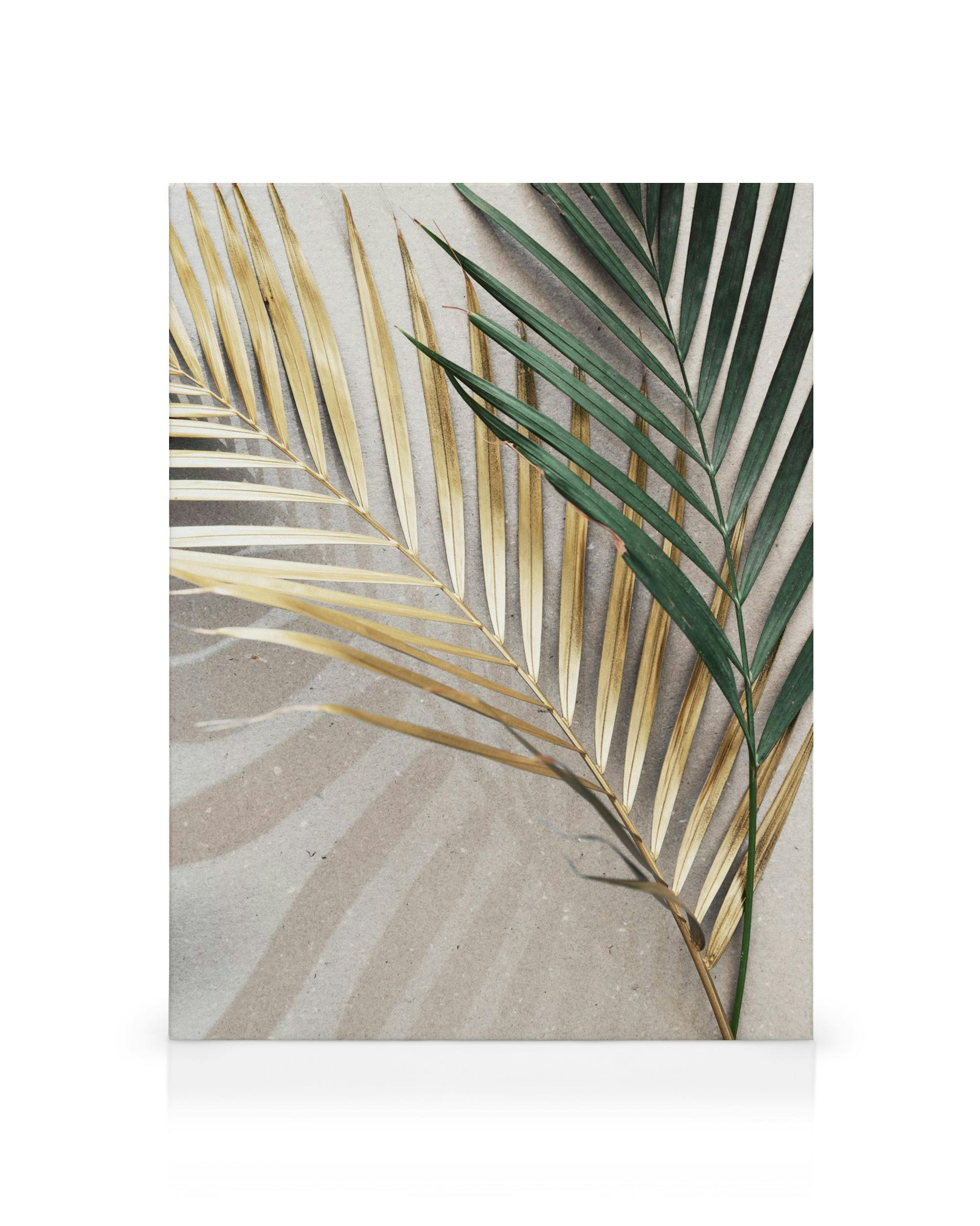 Golden Leaves Canvas print featuring two palm leaves, one gold and one green, on a beige background.