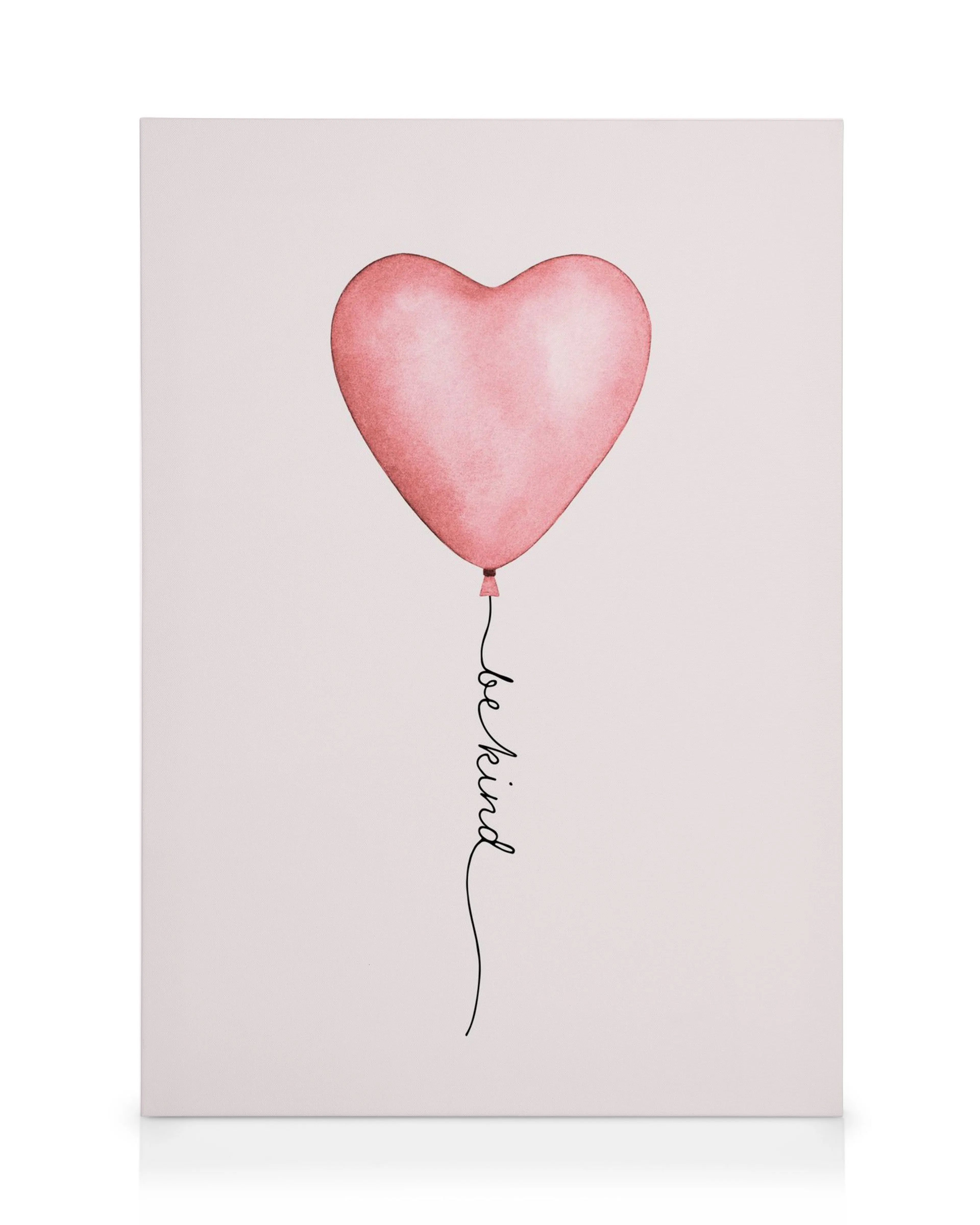 Pink heart balloon canvas print with Be Kind in cursive black ink, soft wall art