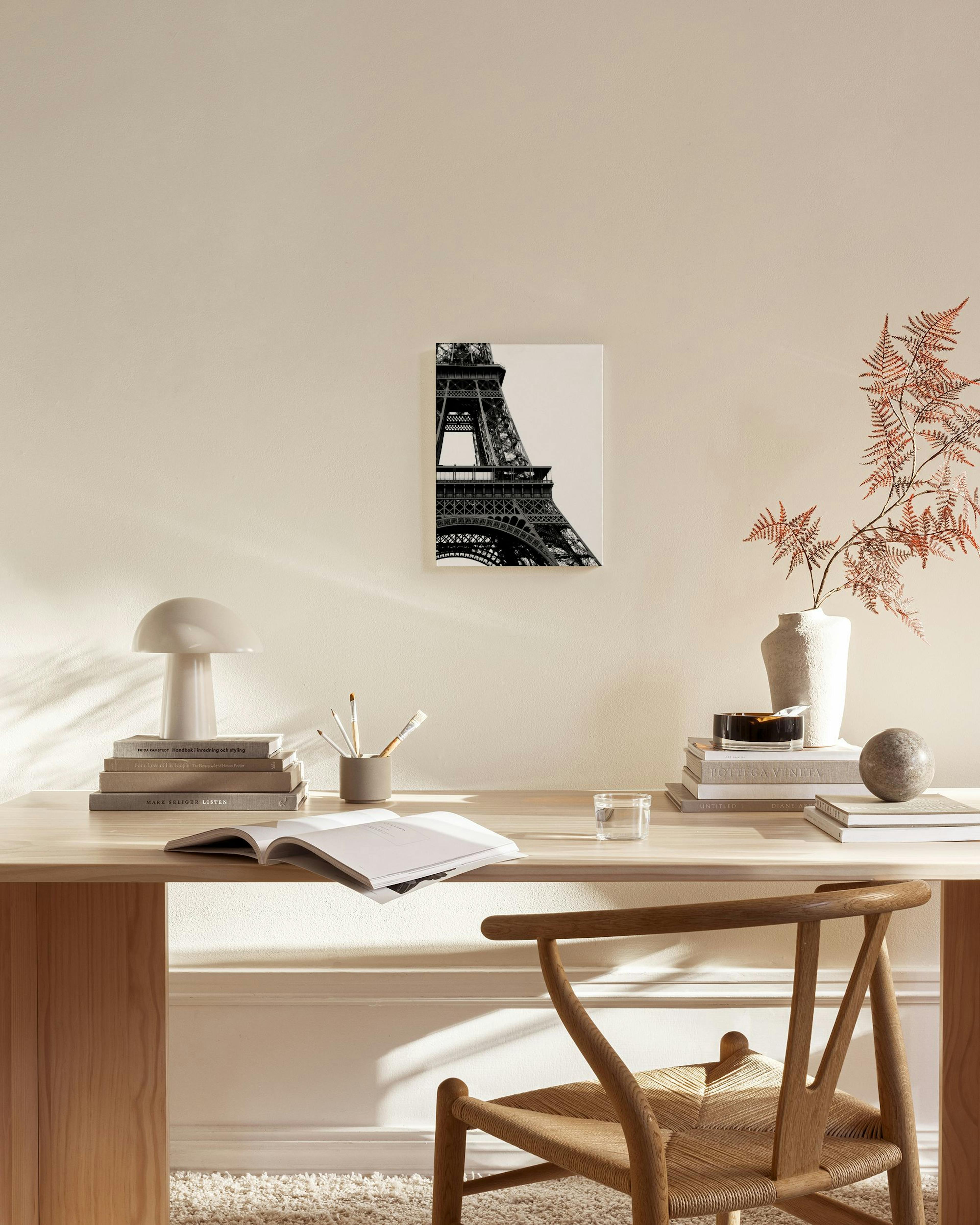 Black and white print of the Eiffel Tower, displayed in a living room above a wooden console table.