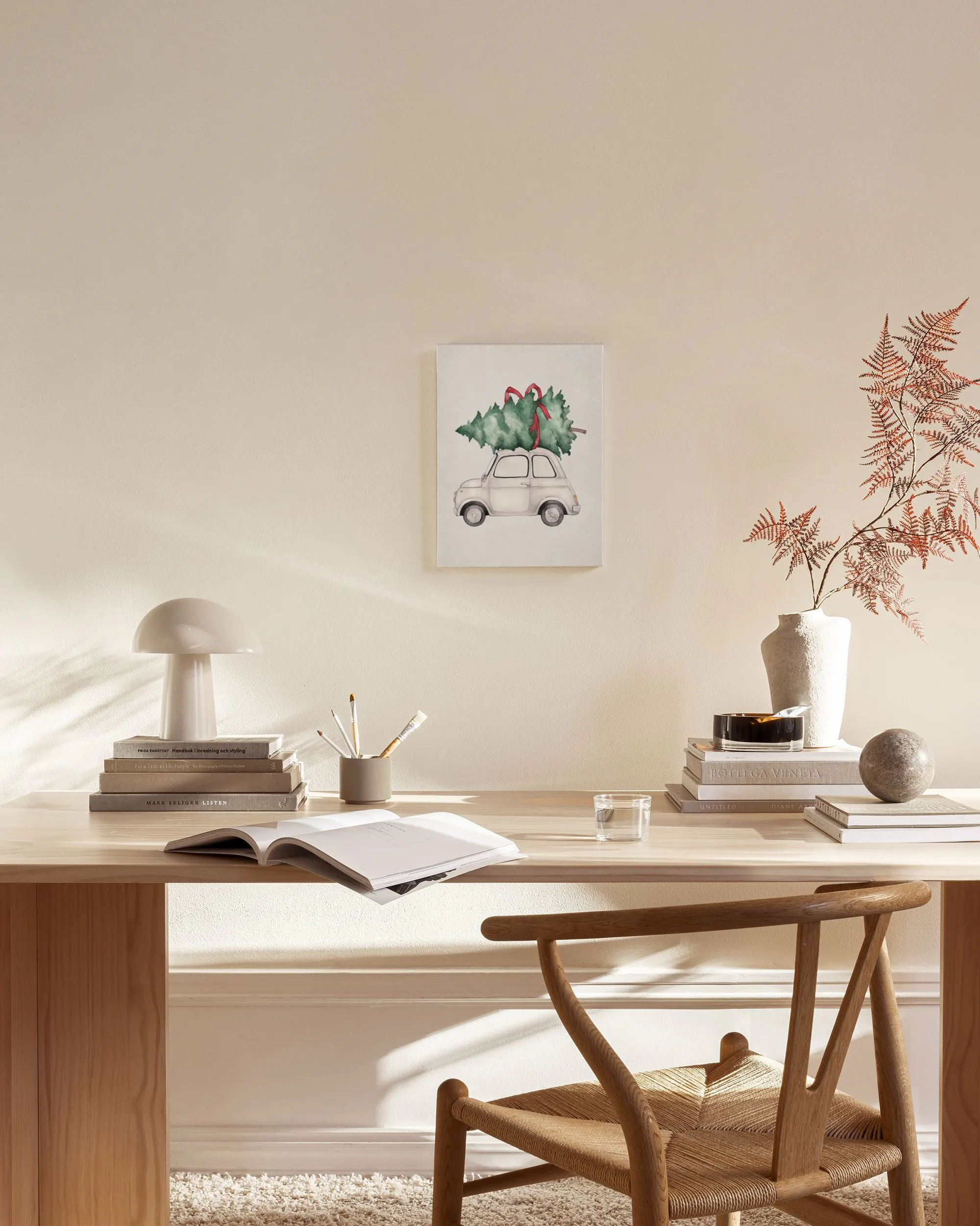 Canvas met witte auto die kerstboom vervoert, hangend in een neutrale woonkamer boven een dressoir.