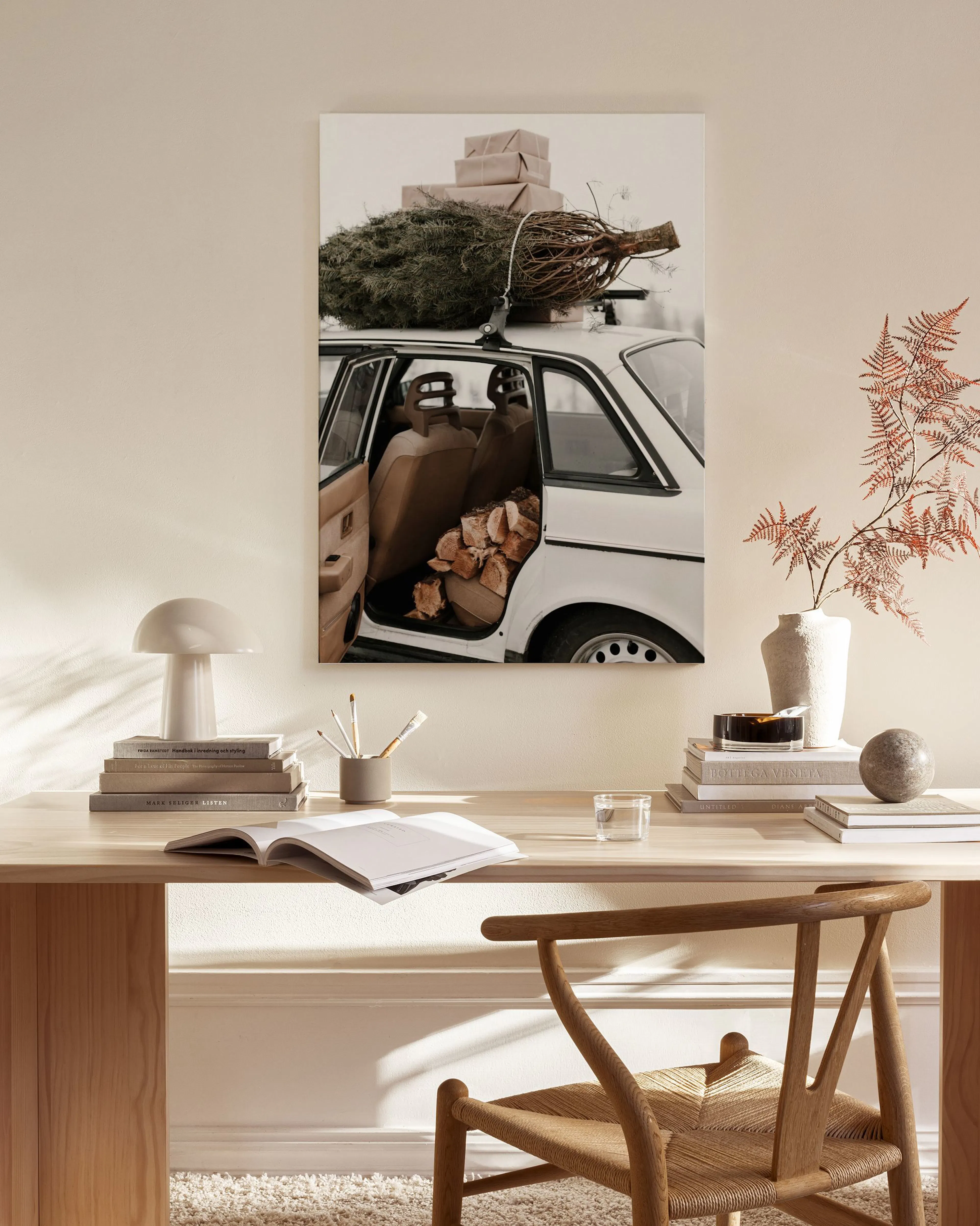 Canvas print of a white vintage car with a Christmas tree and gifts on the roof, displayed in a modern living room.