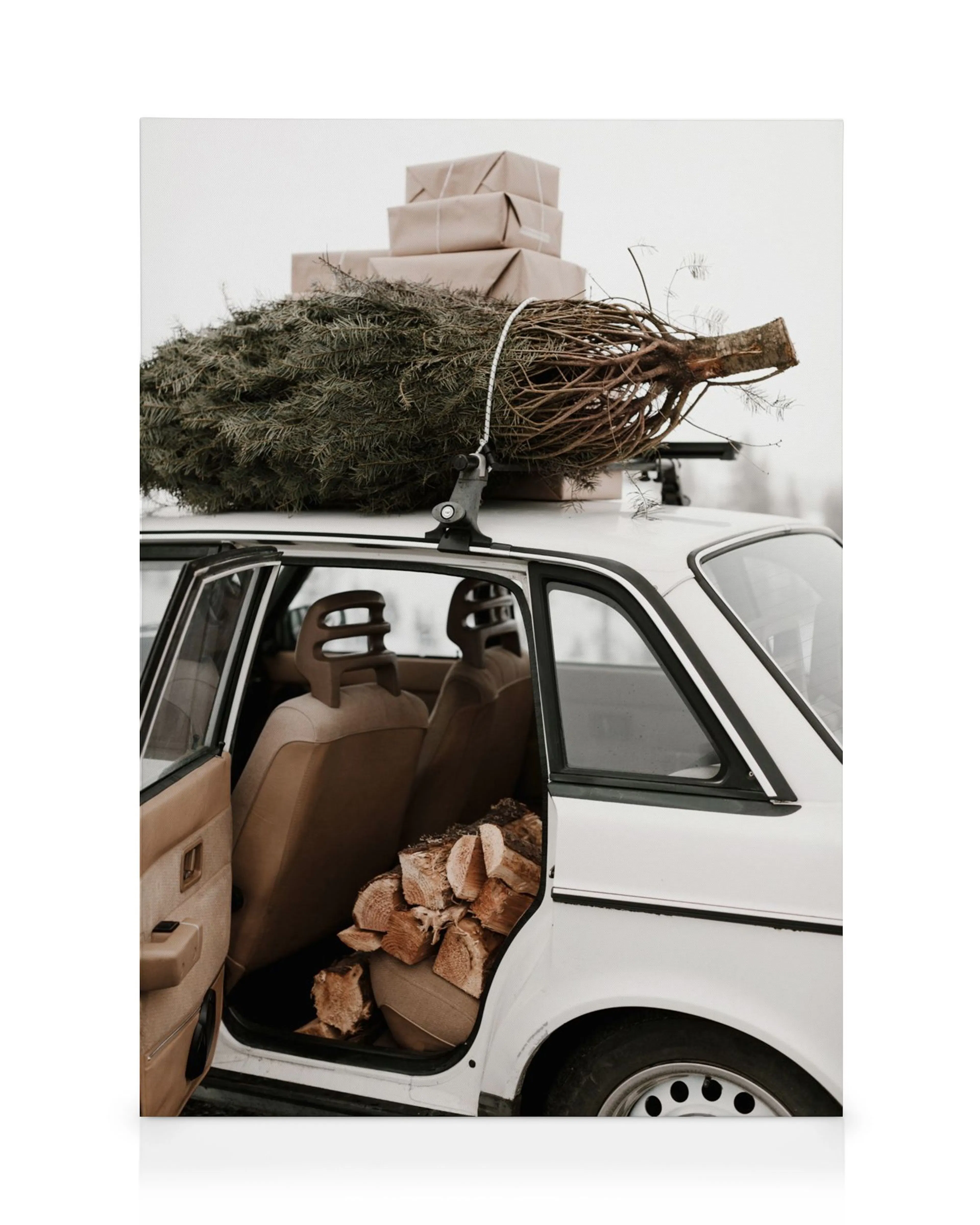 Holiday car canvas print featuring a white car with a Christmas tree and wrapped presents on the roof, and firewood inside.
