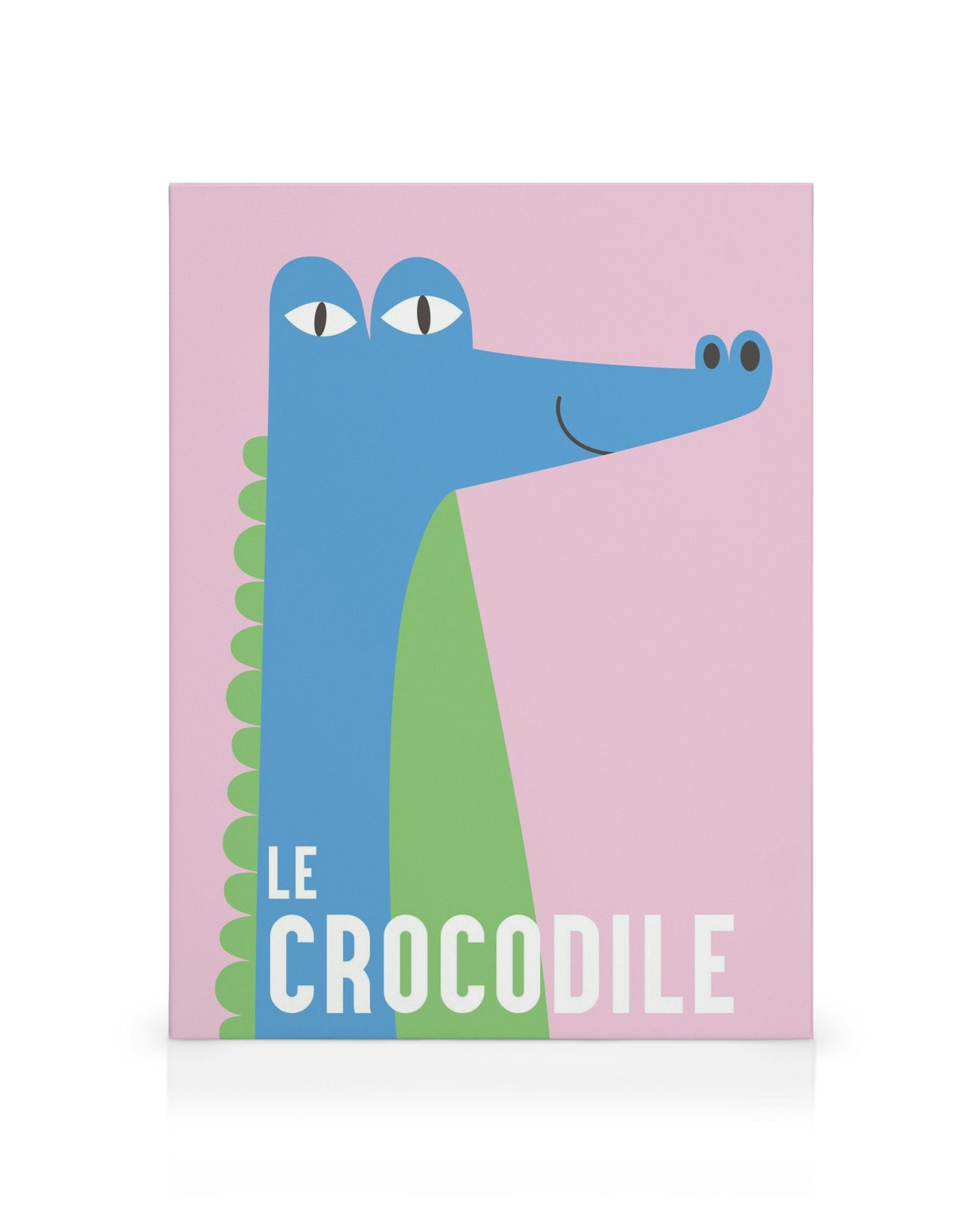 Quadro em tela Le Crocodile com crocodilo azul estilizado, barriga verde, olhos brancos em fundo rosa. Arte infantil.
