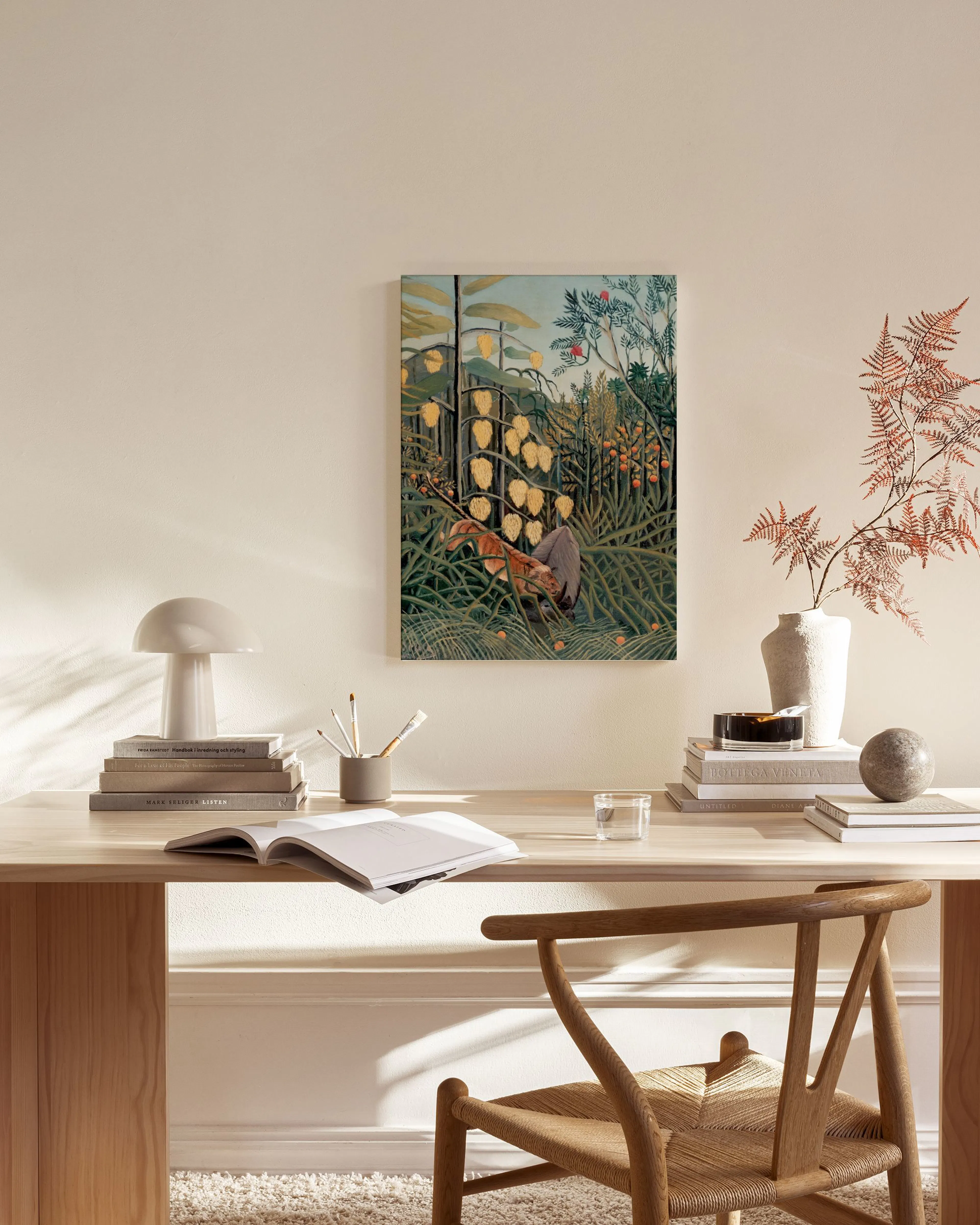 A jungle scene with a lion and glowing yellow lanterns, hanging in a minimalist living room above a wooden console.
