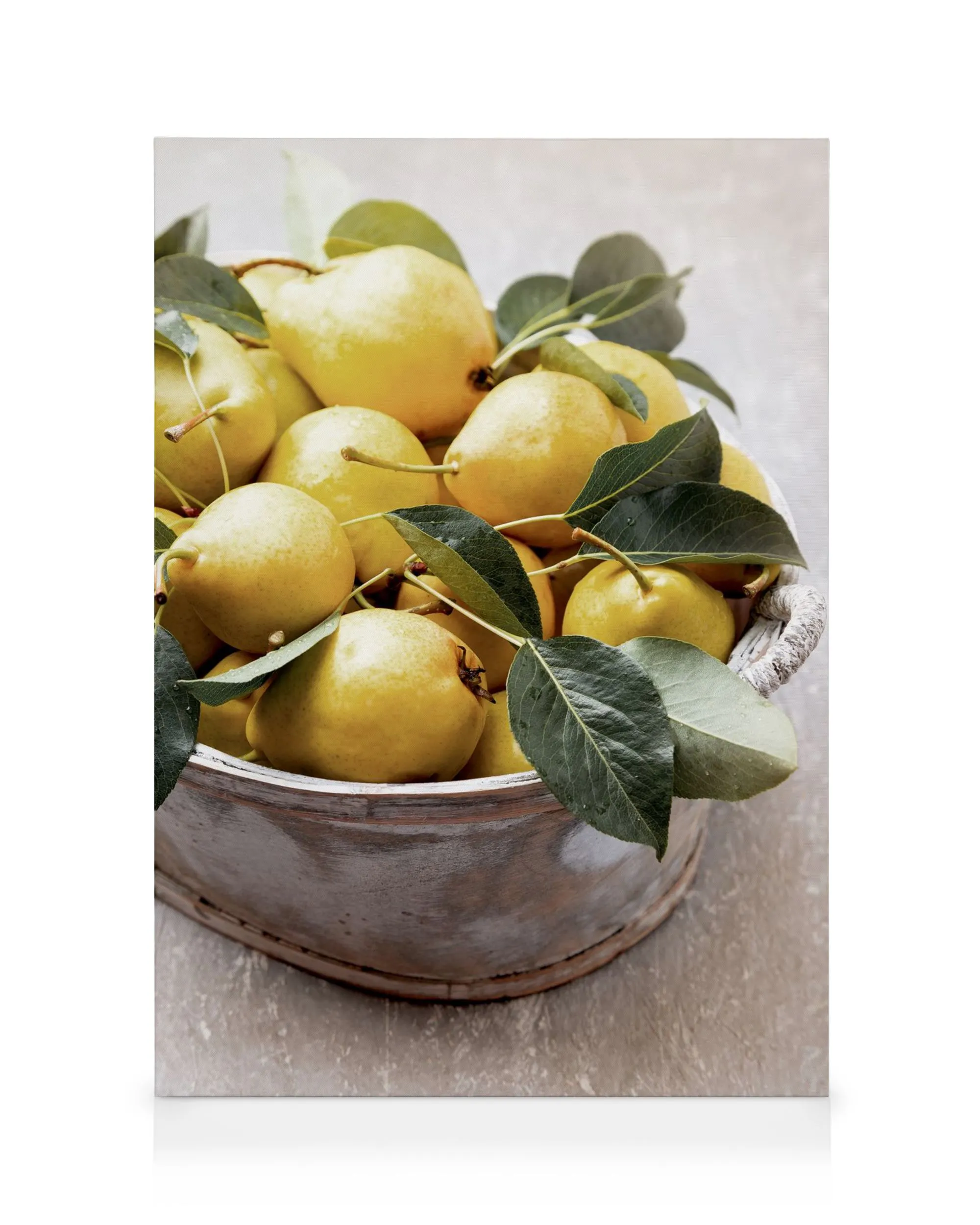 Close-up of a rustic wooden bowl overflowing with ripe yellow pears and green leaves, evoking summer fruit abundance.