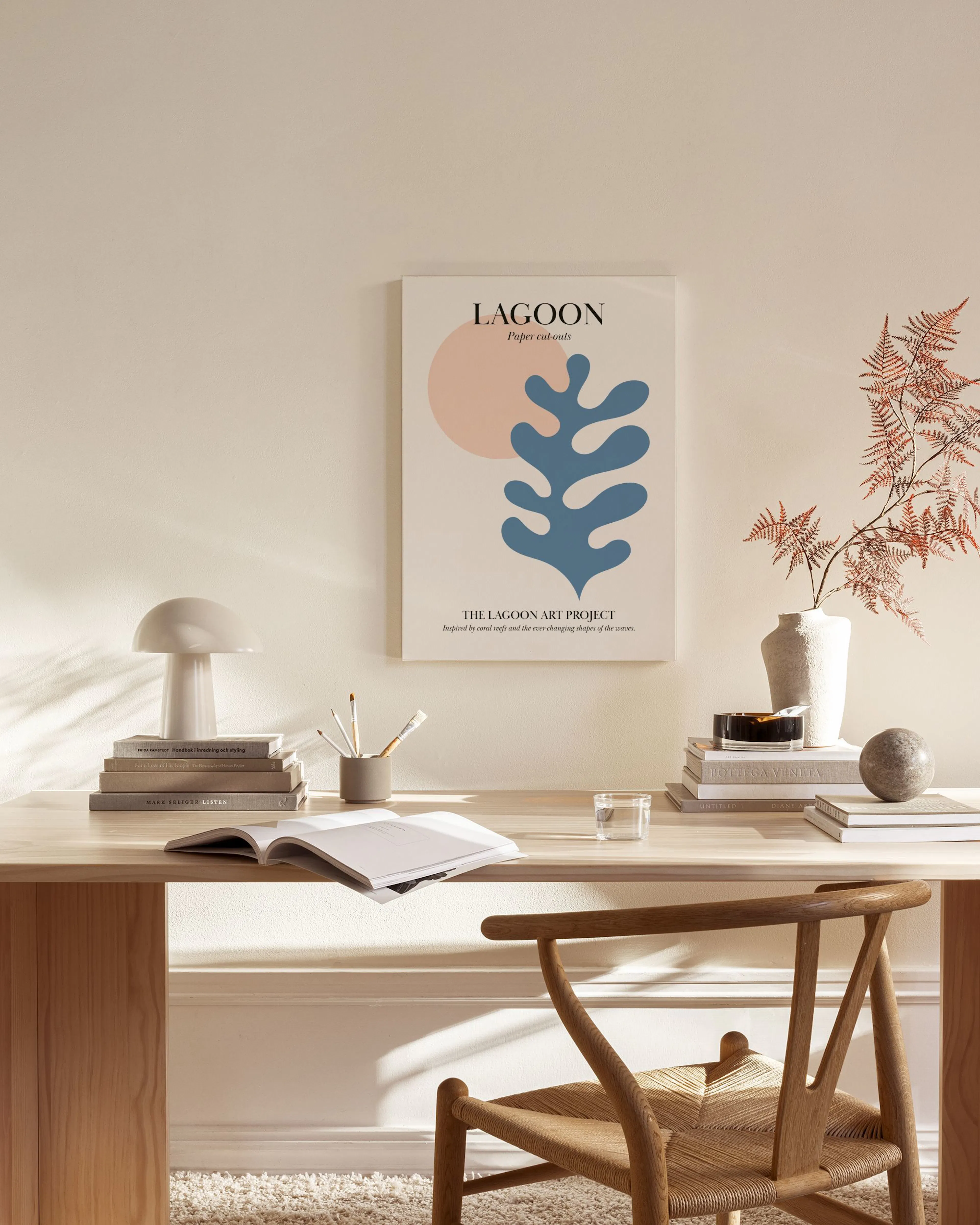 Abstract print with a blue coral-like shape and a peach sun on a light background.