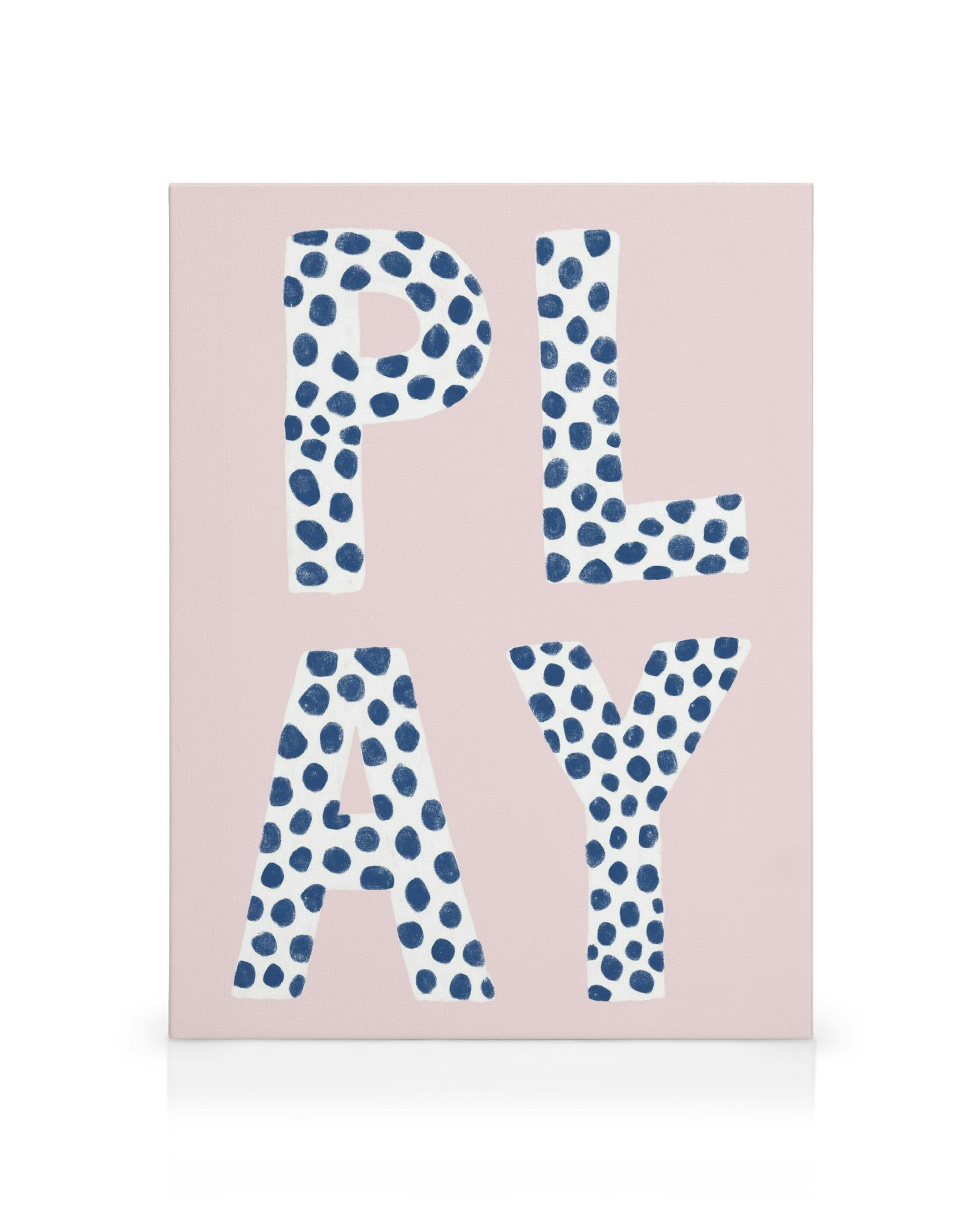 Canvas print with white Play letters featuring blue dots on a light pink background, perfect for playrooms.
