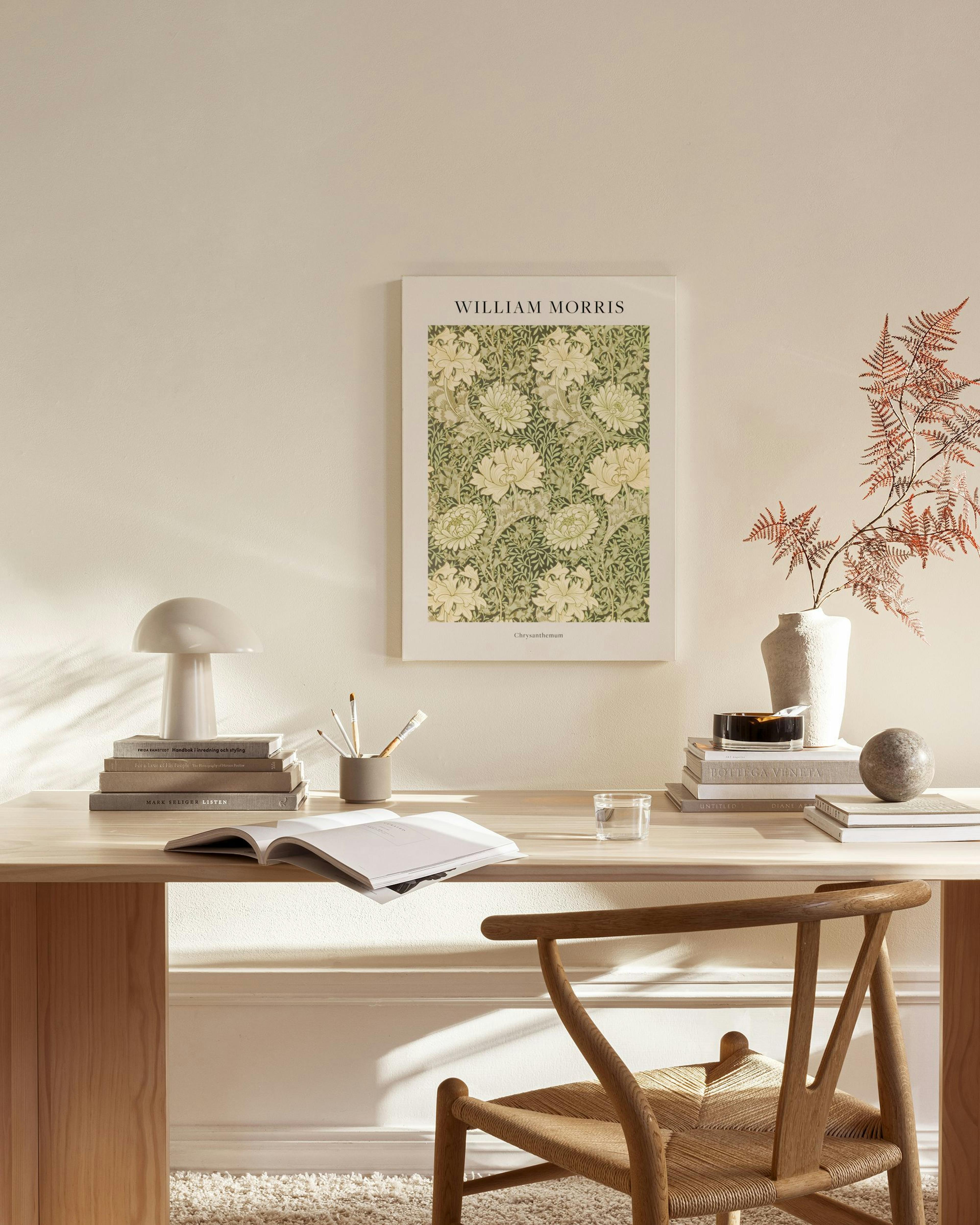 William Morris Chrysanthemum print with green foliage and light yellow flowers, displayed in a modern living room.