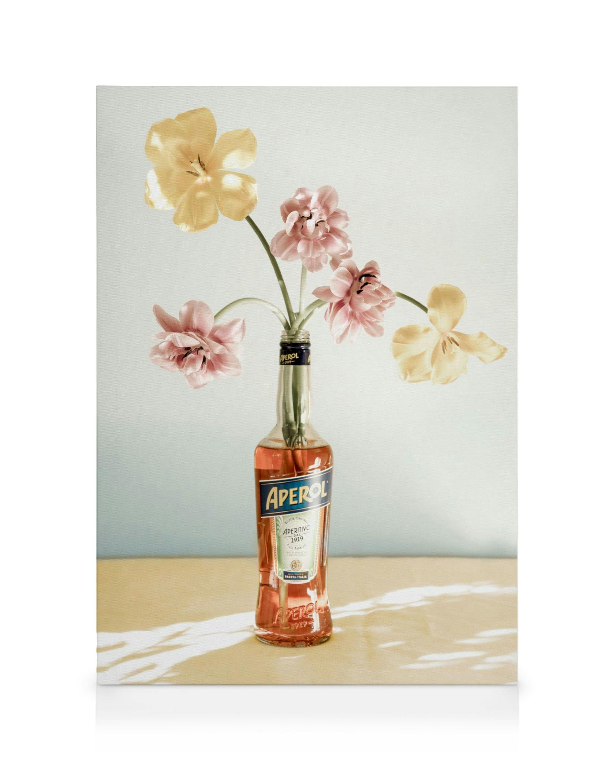 Aperol bottle with pink and yellow flowers, modern floral canvas print, drink art.