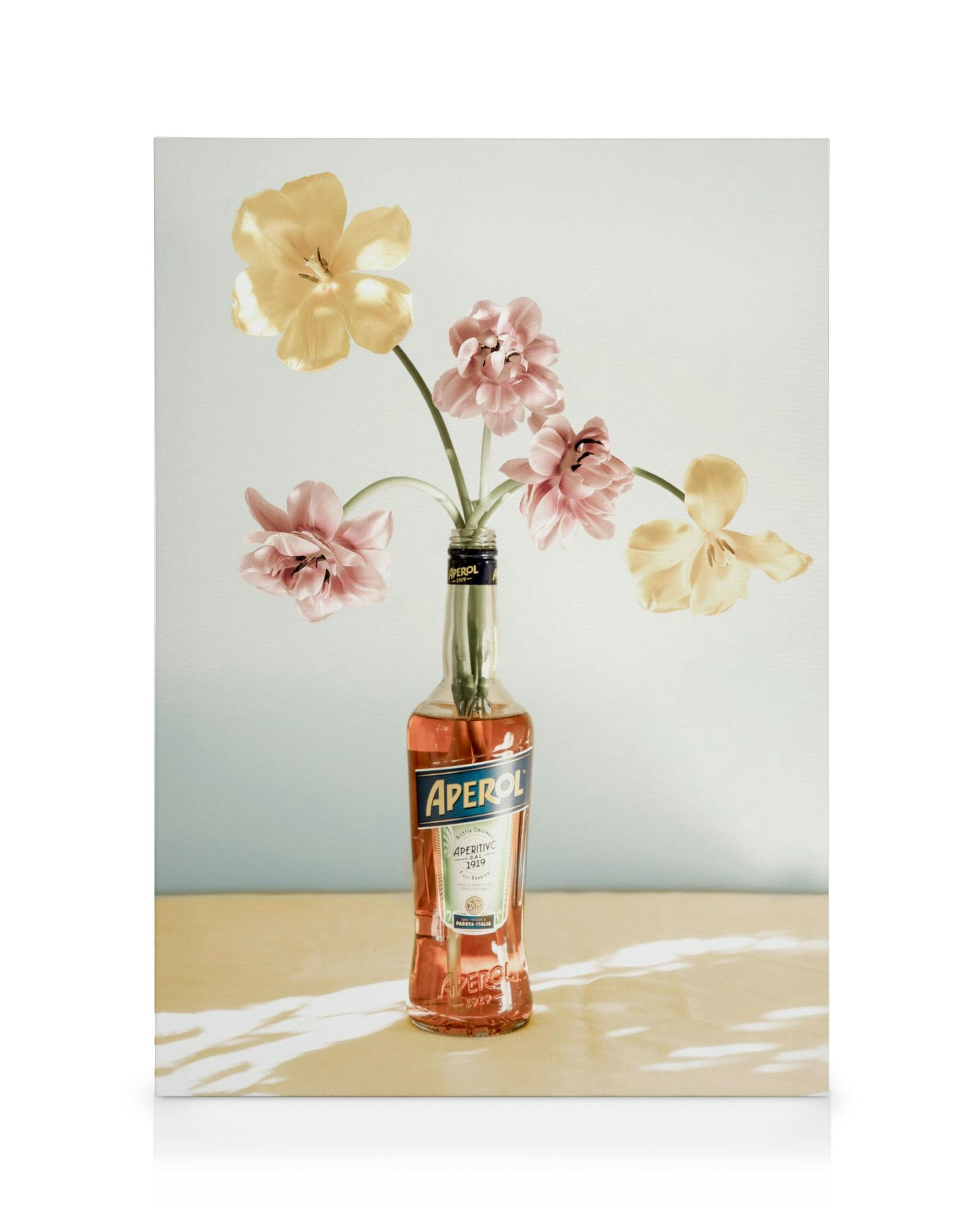 Aperol bottle with pink and yellow flowers, modern floral canvas print, drink art.