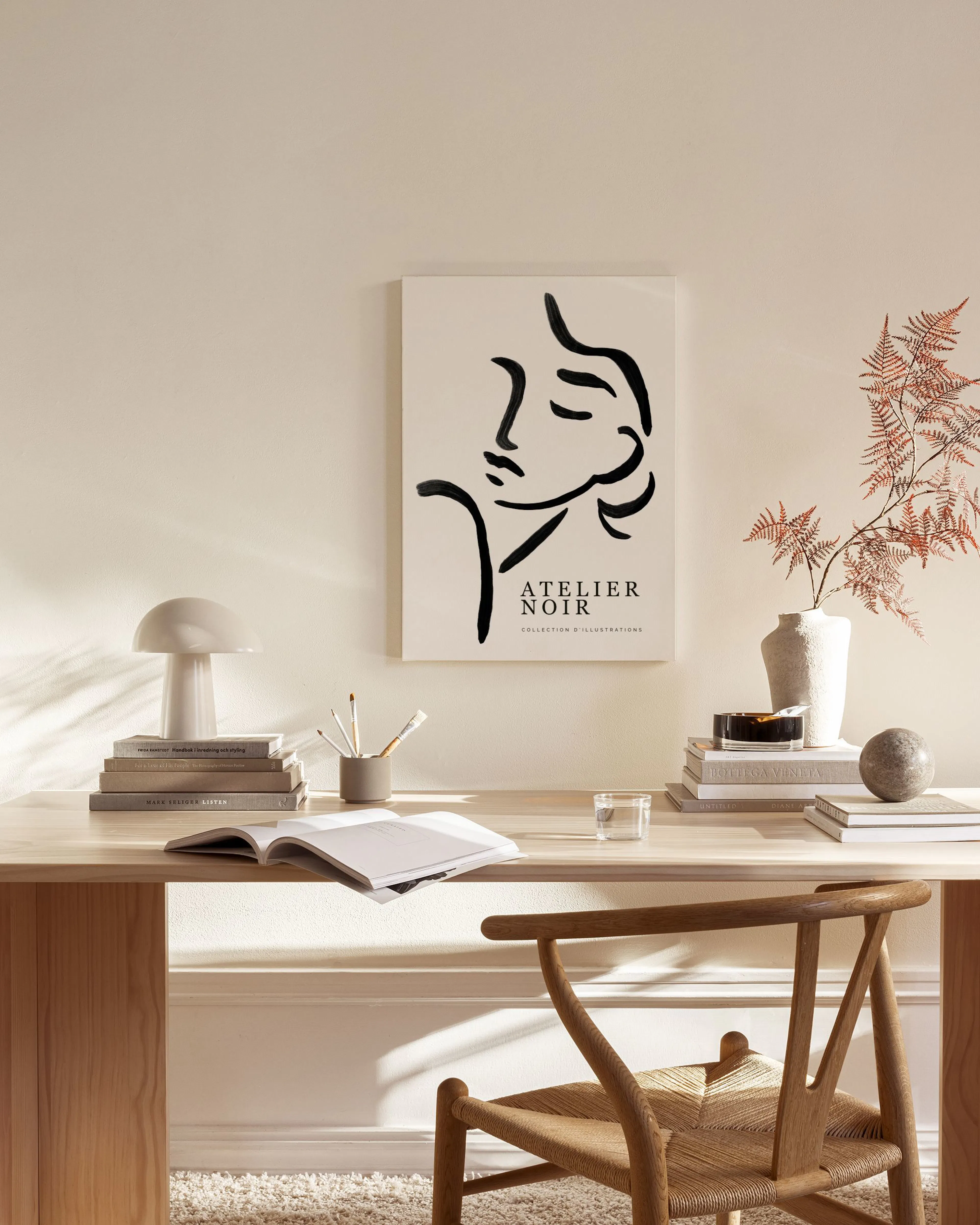 A black line art profile of a womans face on a light background, hanging in a minimalist living room.