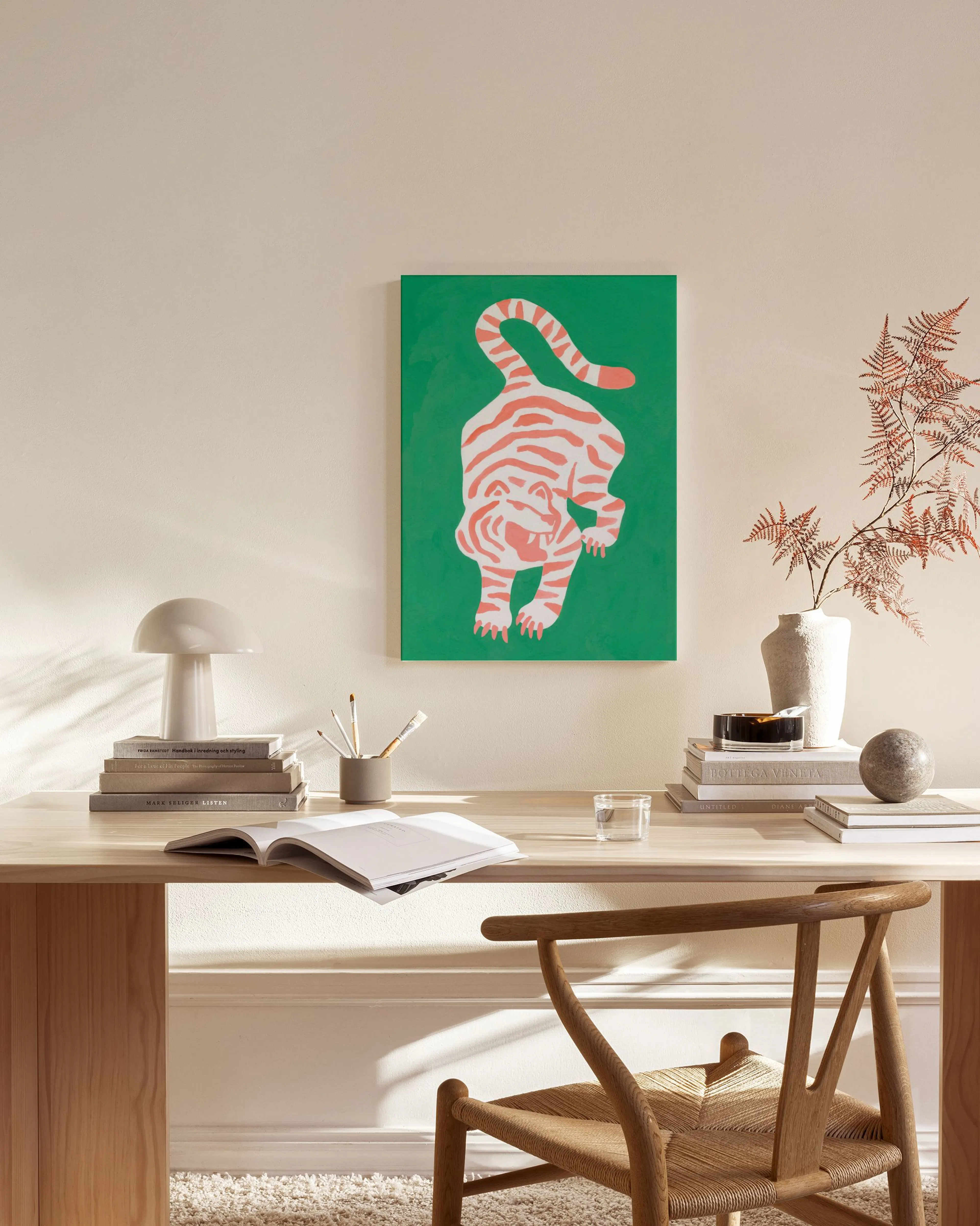 A vibrant green canvas print of an orange and white striped tiger, displayed in a modern living room above a wooden console.