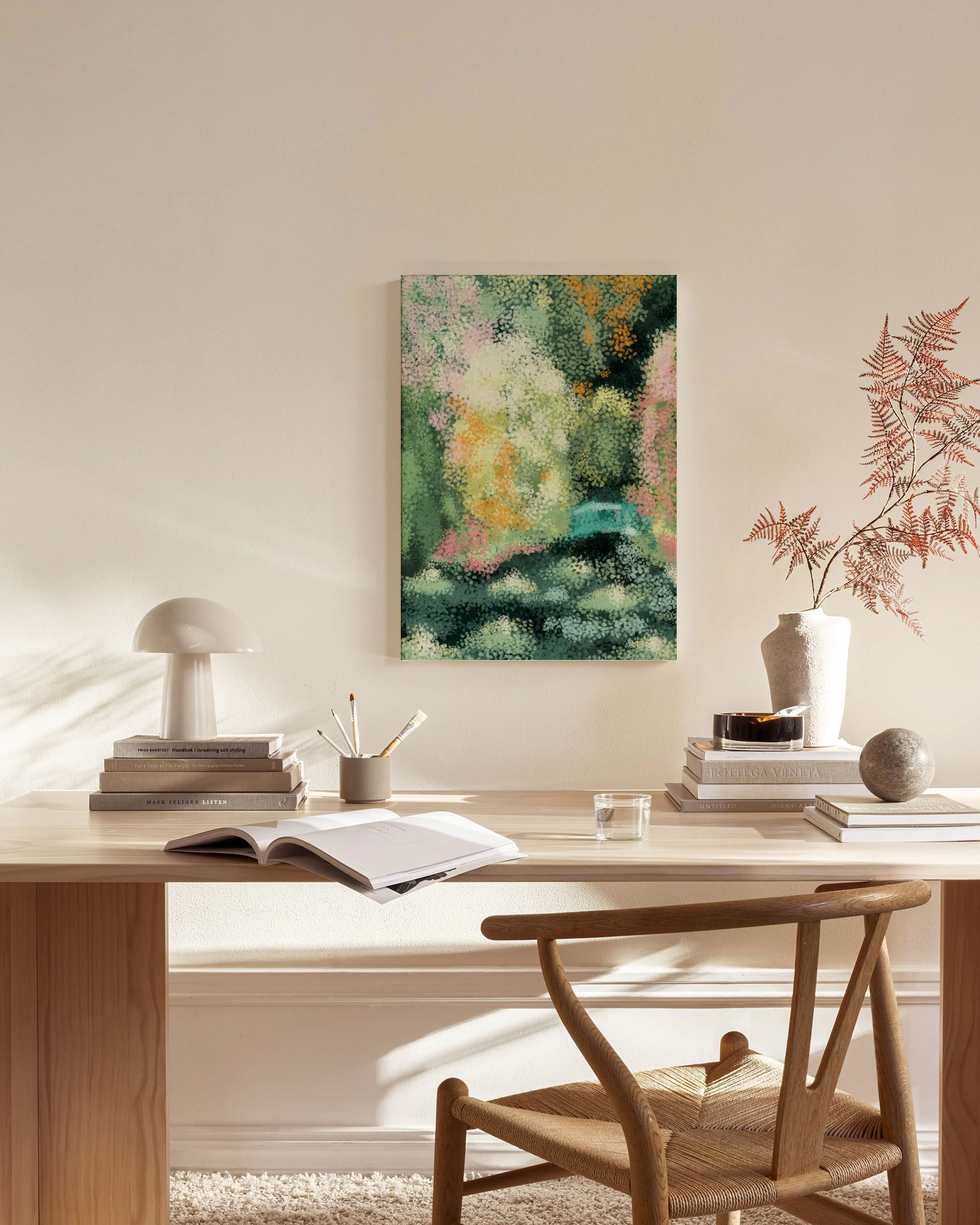 Abstract canvas print with green, pink, and yellow pointillism, hanging in a bright living room over a wooden bench.