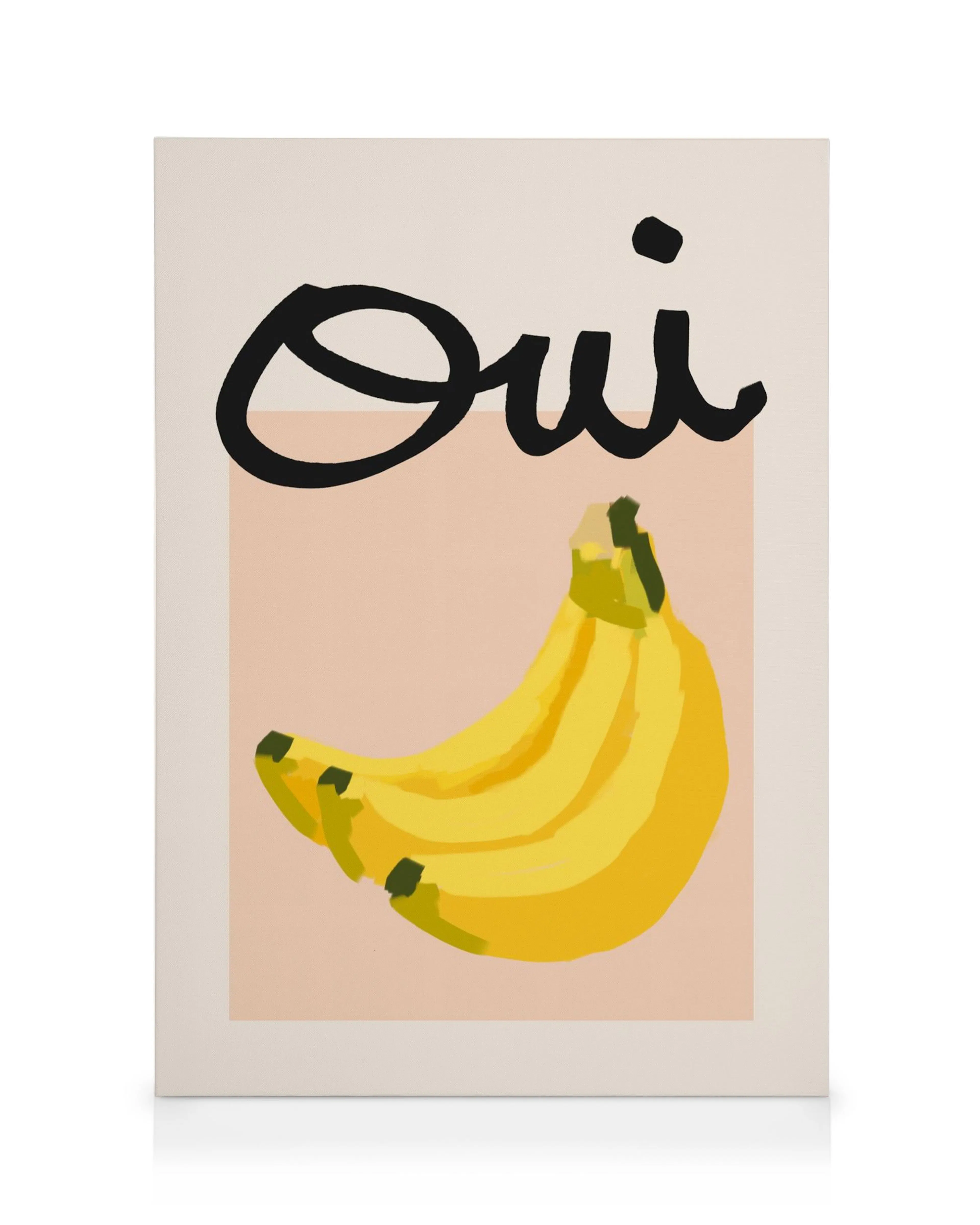 Canvas met gele bananen en zwarte Oui tekst op lichtroze en beige achtergrond. Vrolijke muurkunst.