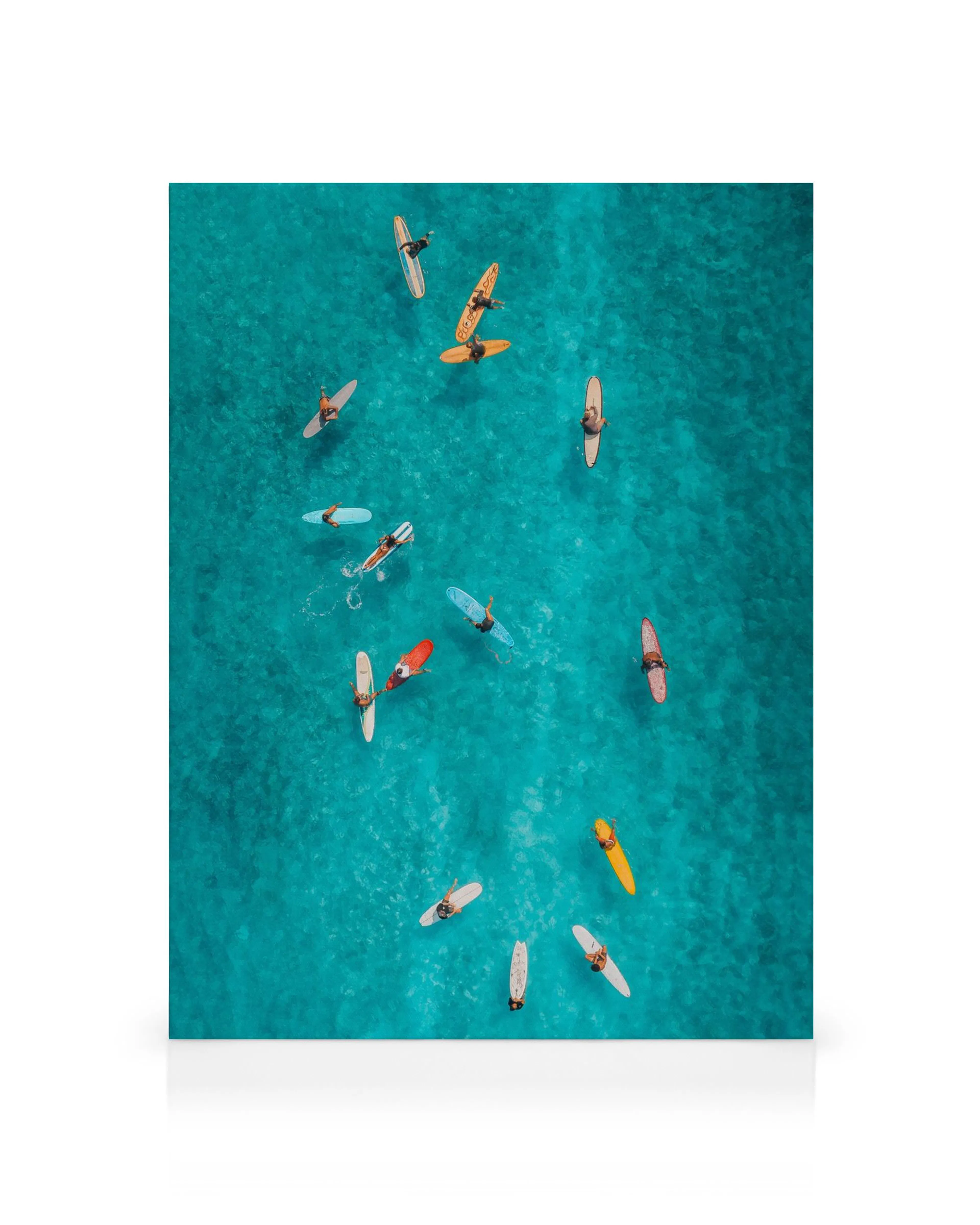 Aerial view of surfers on vibrant turquoise water, a Surfers from Above canvas print.