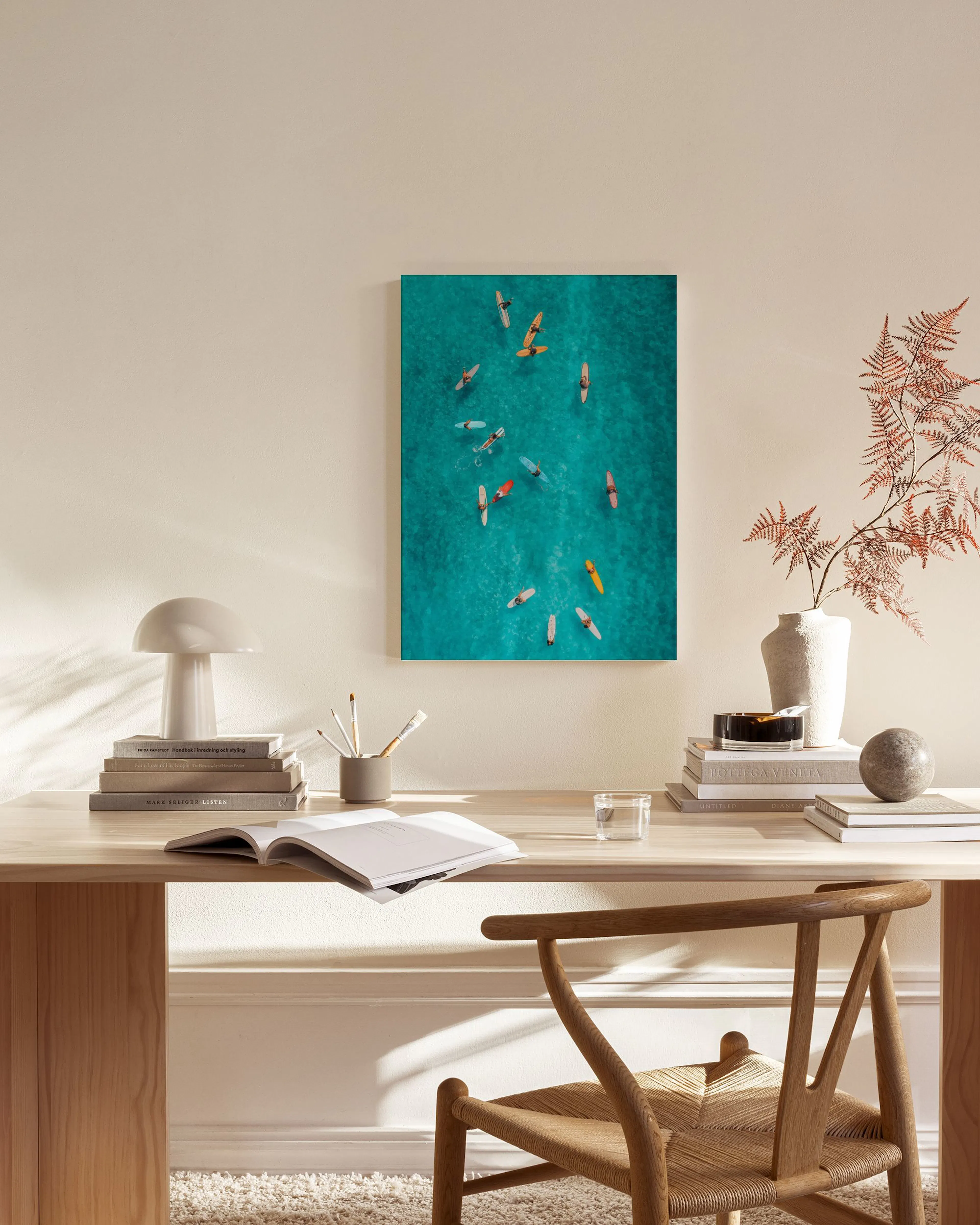 Aerial photo canvas print of colourful paddle boards on clear turquoise water, hanging in a bright, minimalist living room.