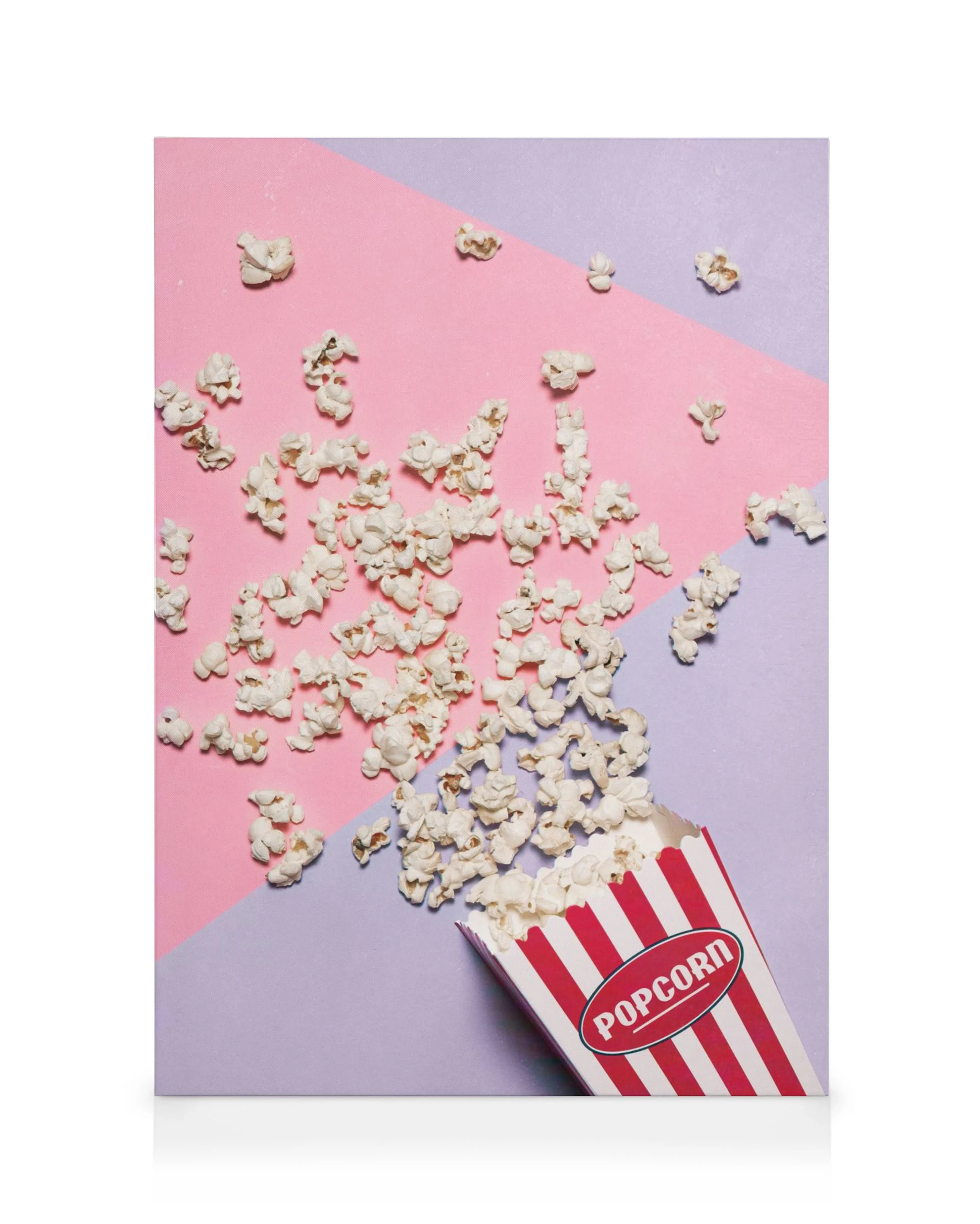 Red and white striped popcorn box with popcorn spilling out on a pink and purple background canvas print