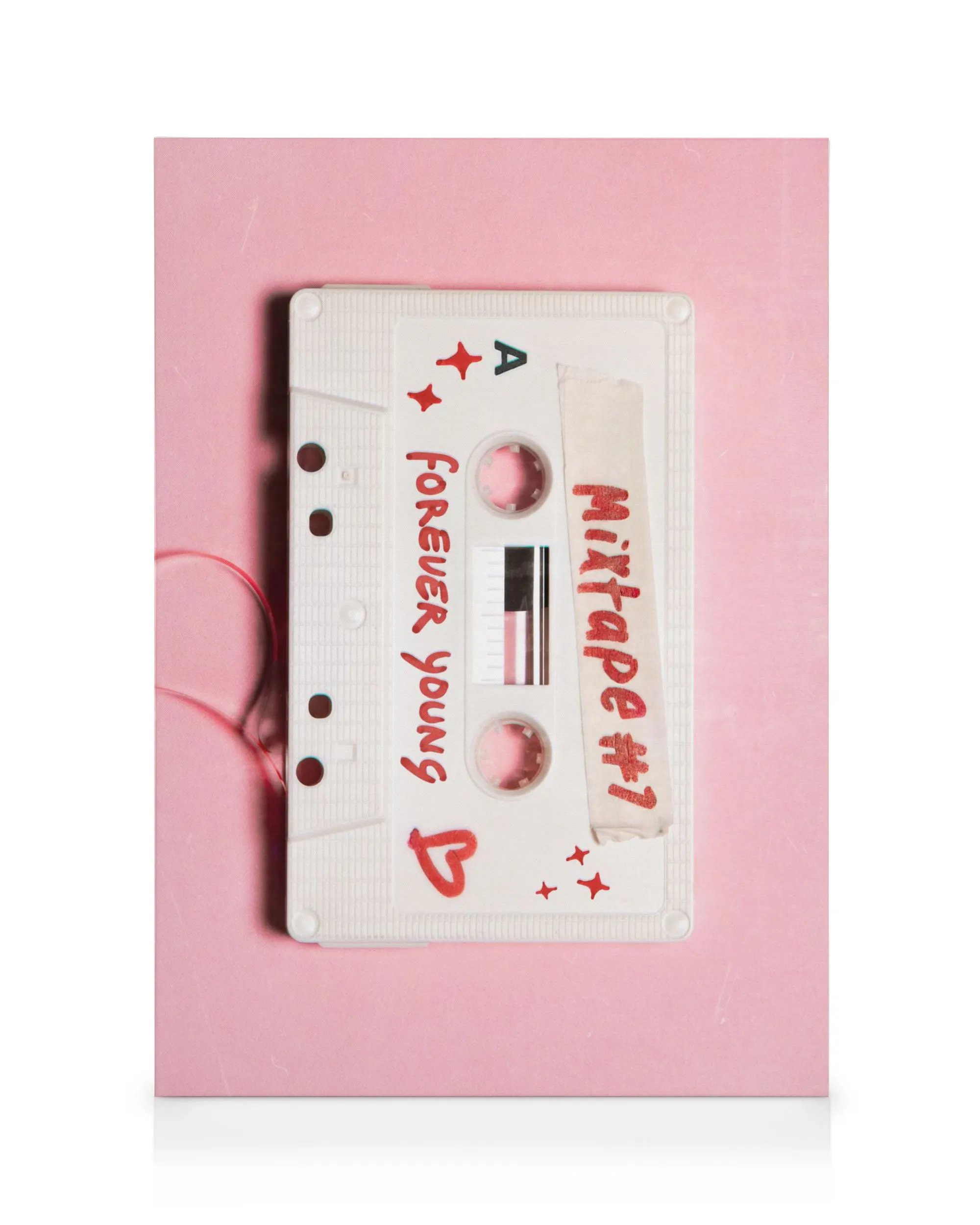 Nostalgic white cassette tape Mixtape #1 and Forever Young on pink background with red stars, canvas print.