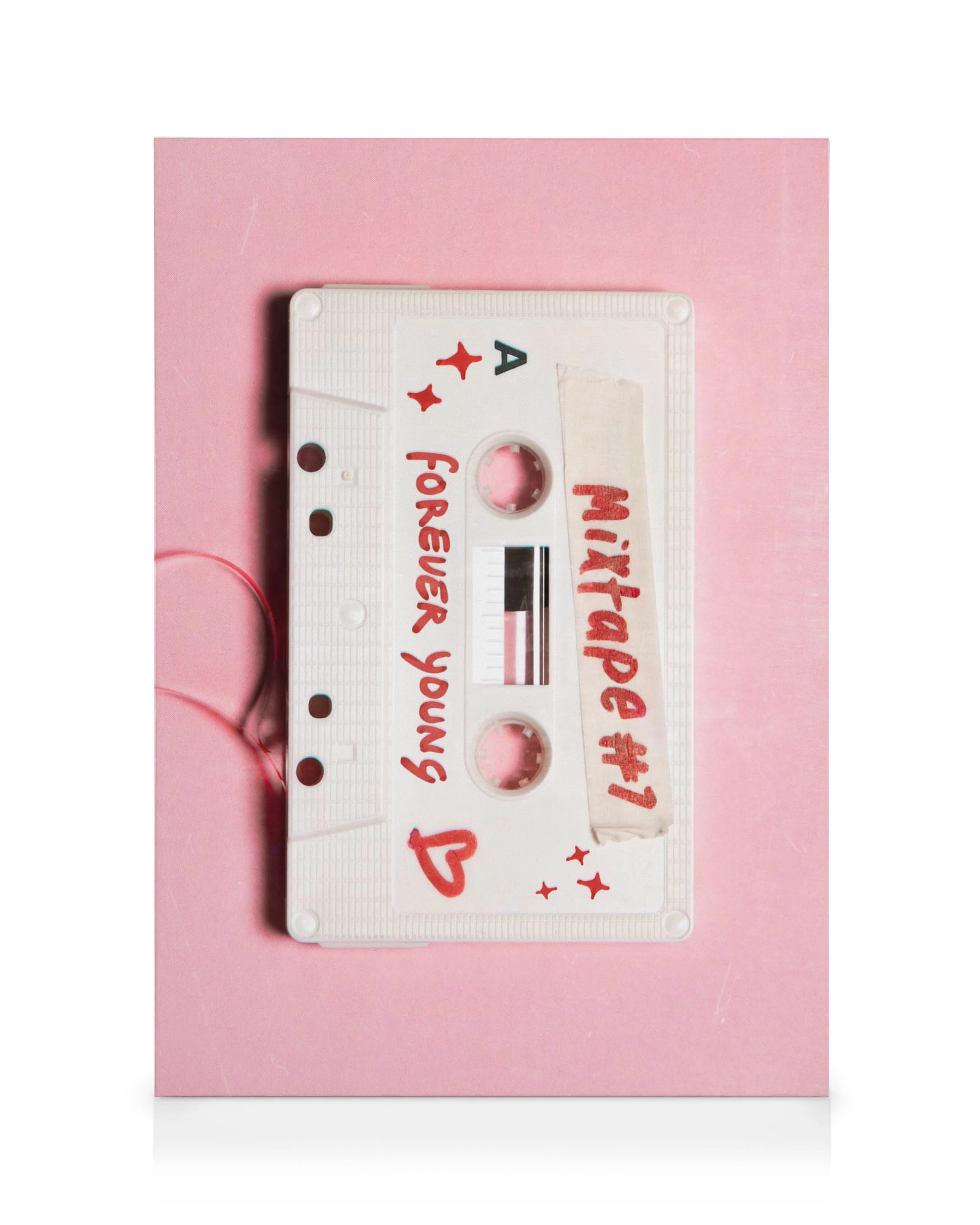 Nostalgic white cassette tape Mixtape #1 and Forever Young on pink background with red stars, canvas print.