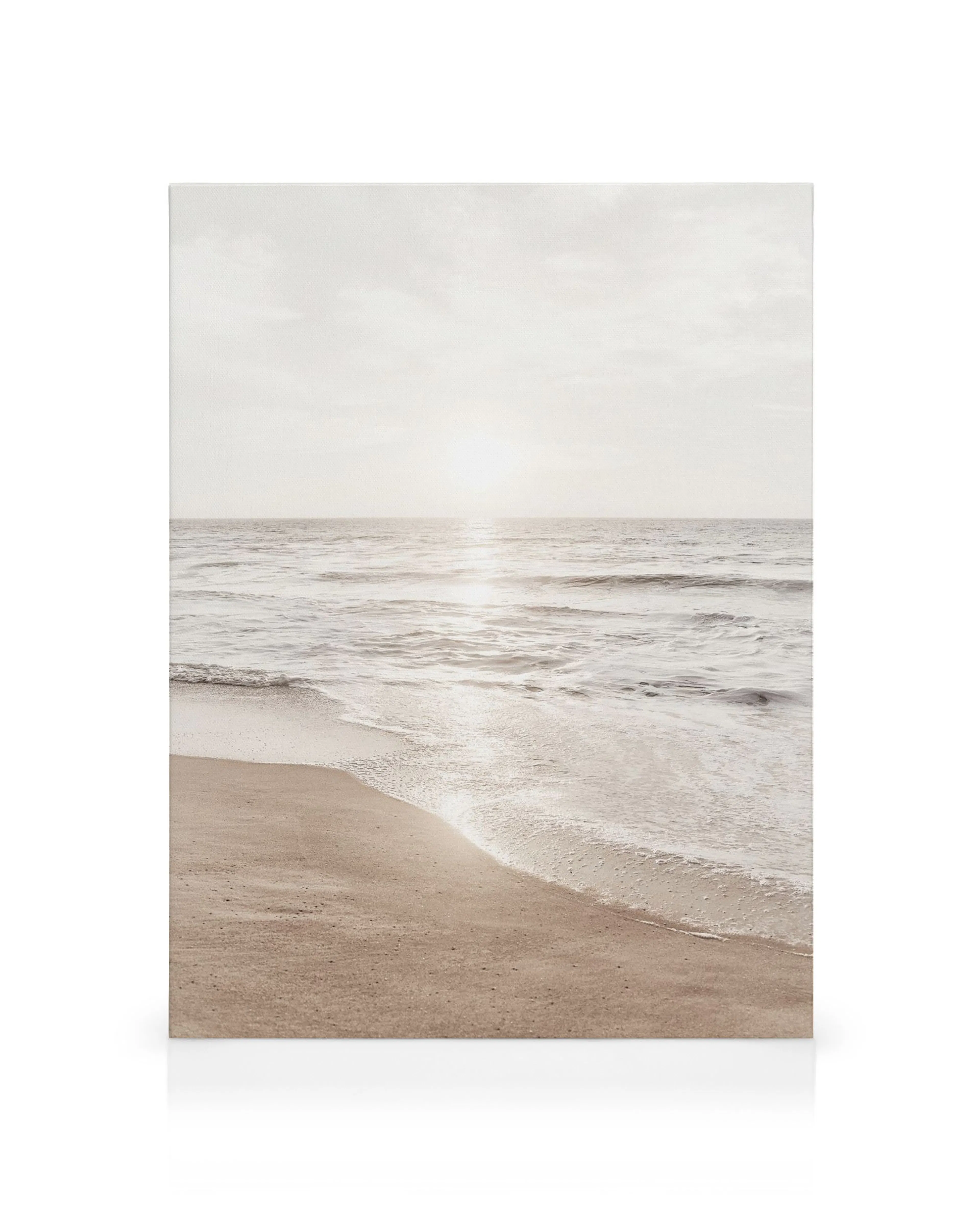 Warm Beach Sunset canvas print, depicting a serene beach with gentle waves and a soft, glowing sunset over the ocean.