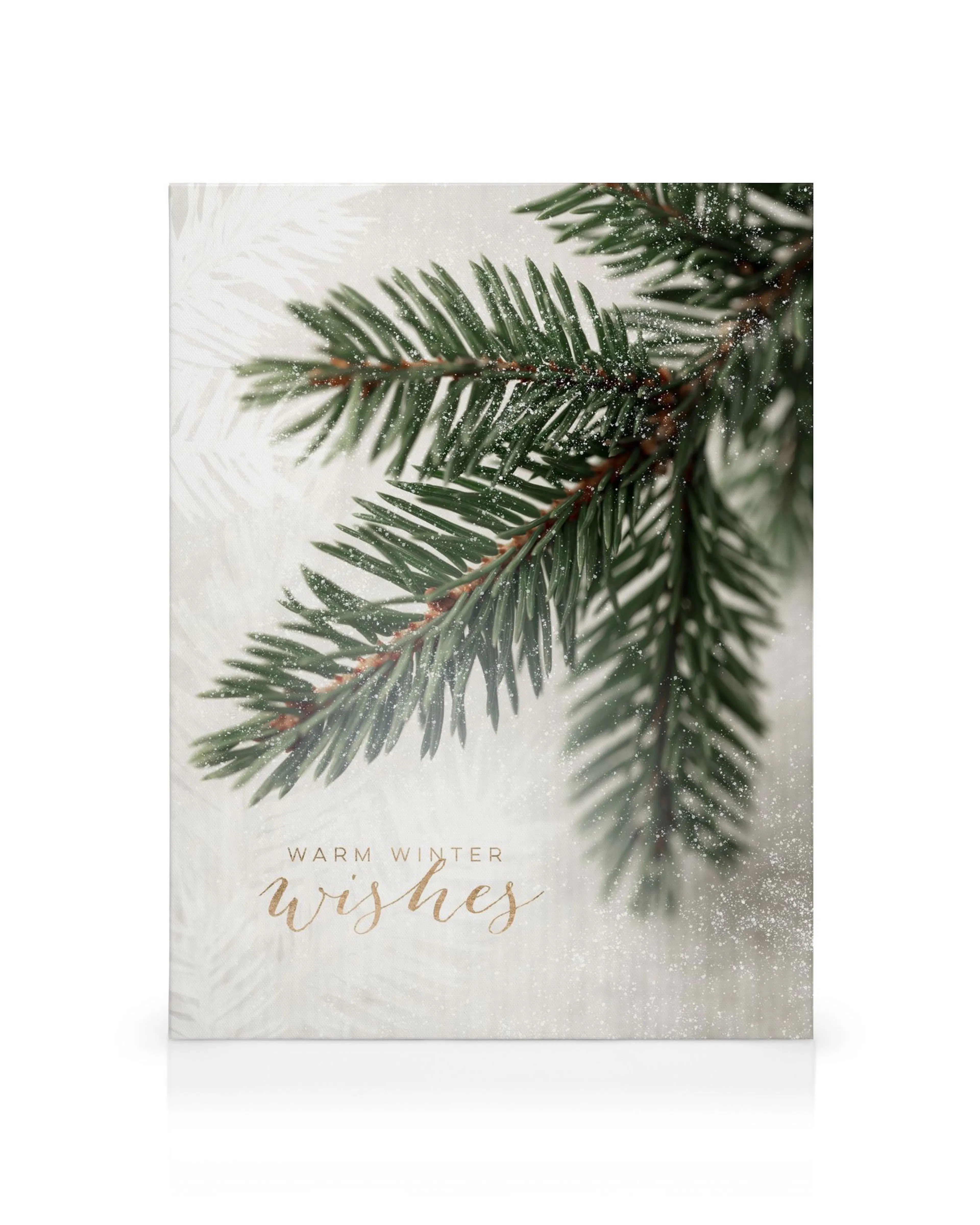 Julelærred med grønne grantræsgrene dækket af sne, og teksten Warm Winter Wishes.