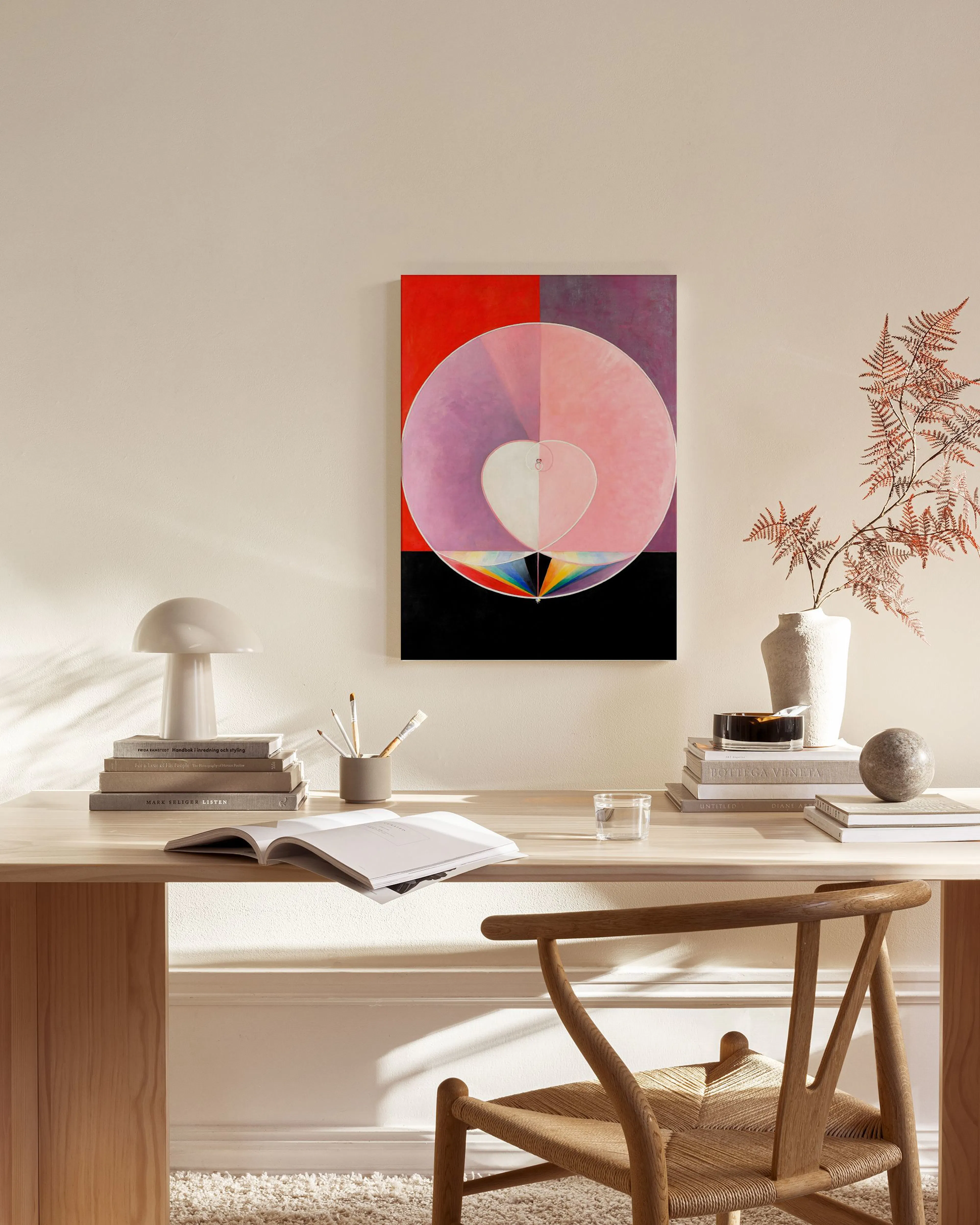 Leinwandbild mit rosa Herz in Kreis auf rotem Grund, hängt über einem Sideboard in modernem Wohnzimmer.