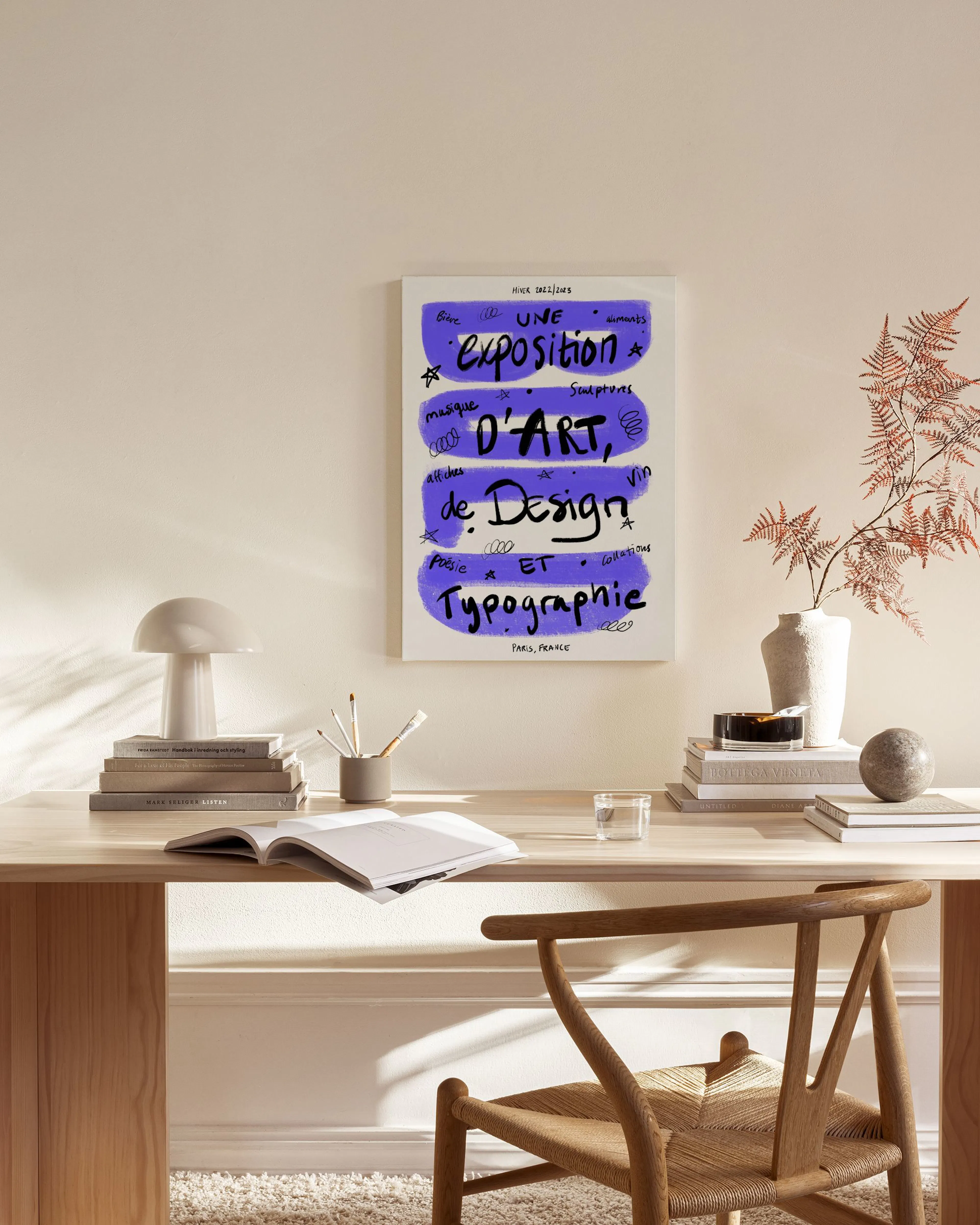 A canvas print with a purple background and black handwritten French text, displayed above a wooden console table in a living ro