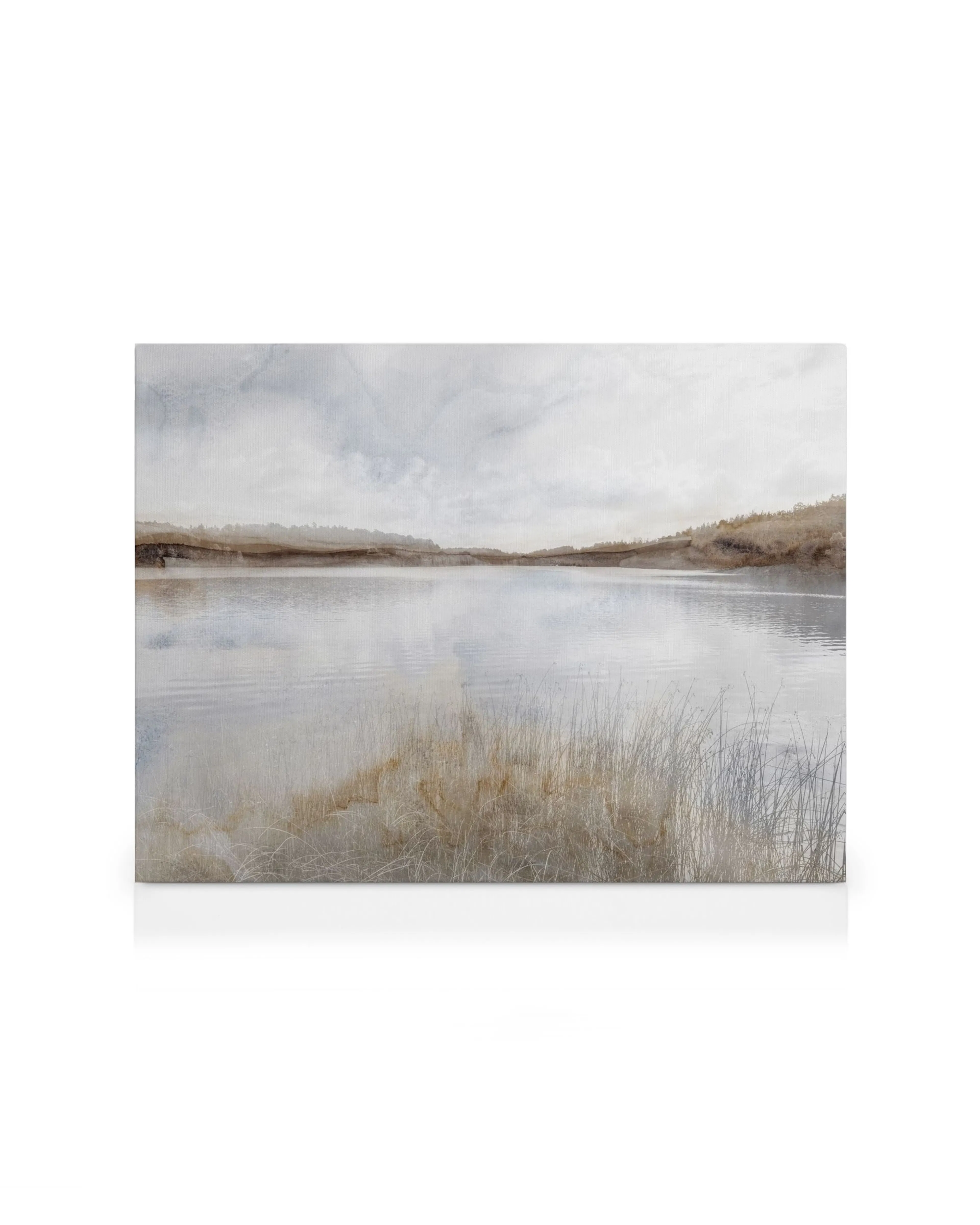 Aquarelle canvas print of a calm lake with muted brown and blue tones, reflecting the sky, with reeds in the foreground.
