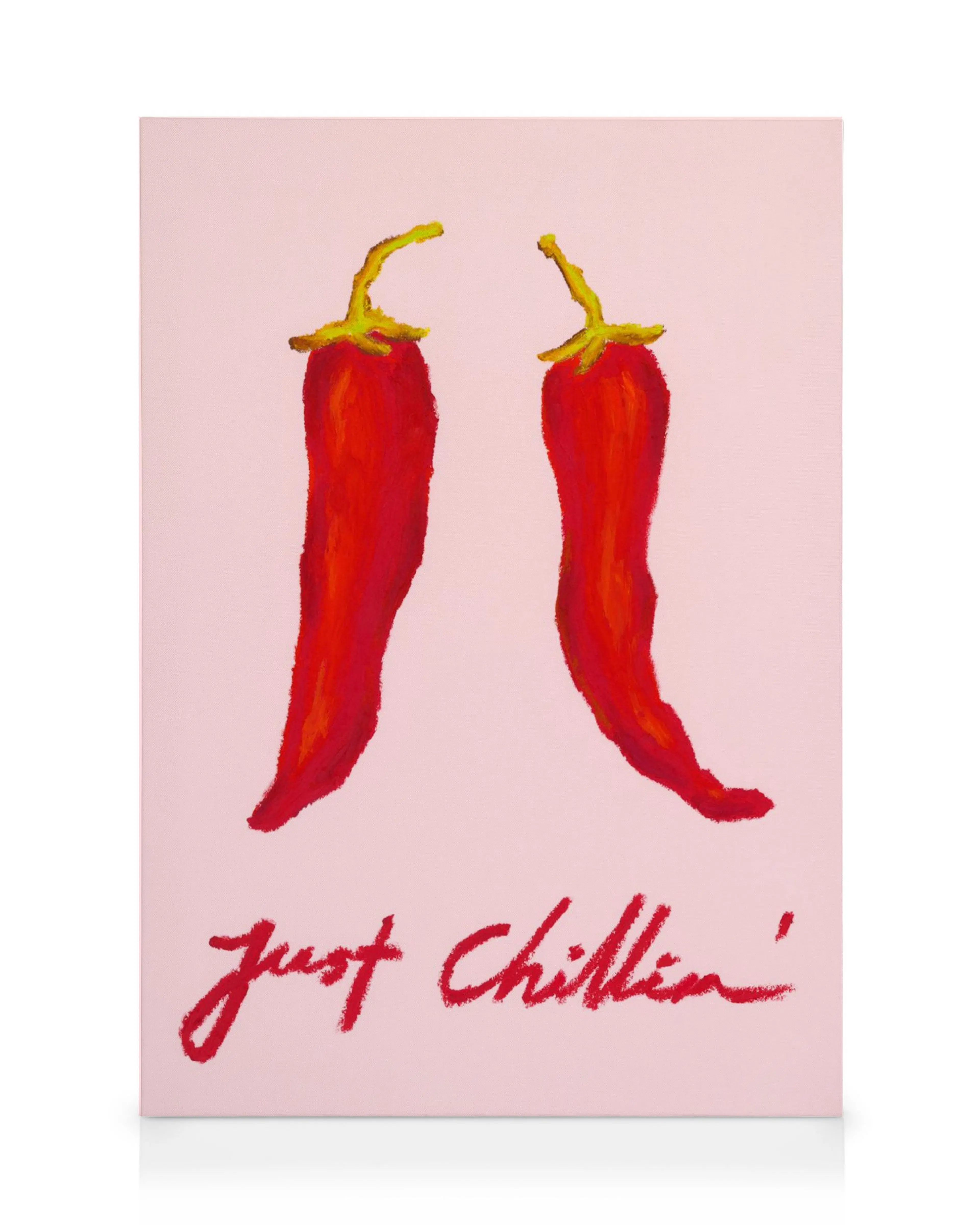 A fun canvas print featuring two red chilli peppers with yellow stems on a pink background, above Just Chillin in red script.