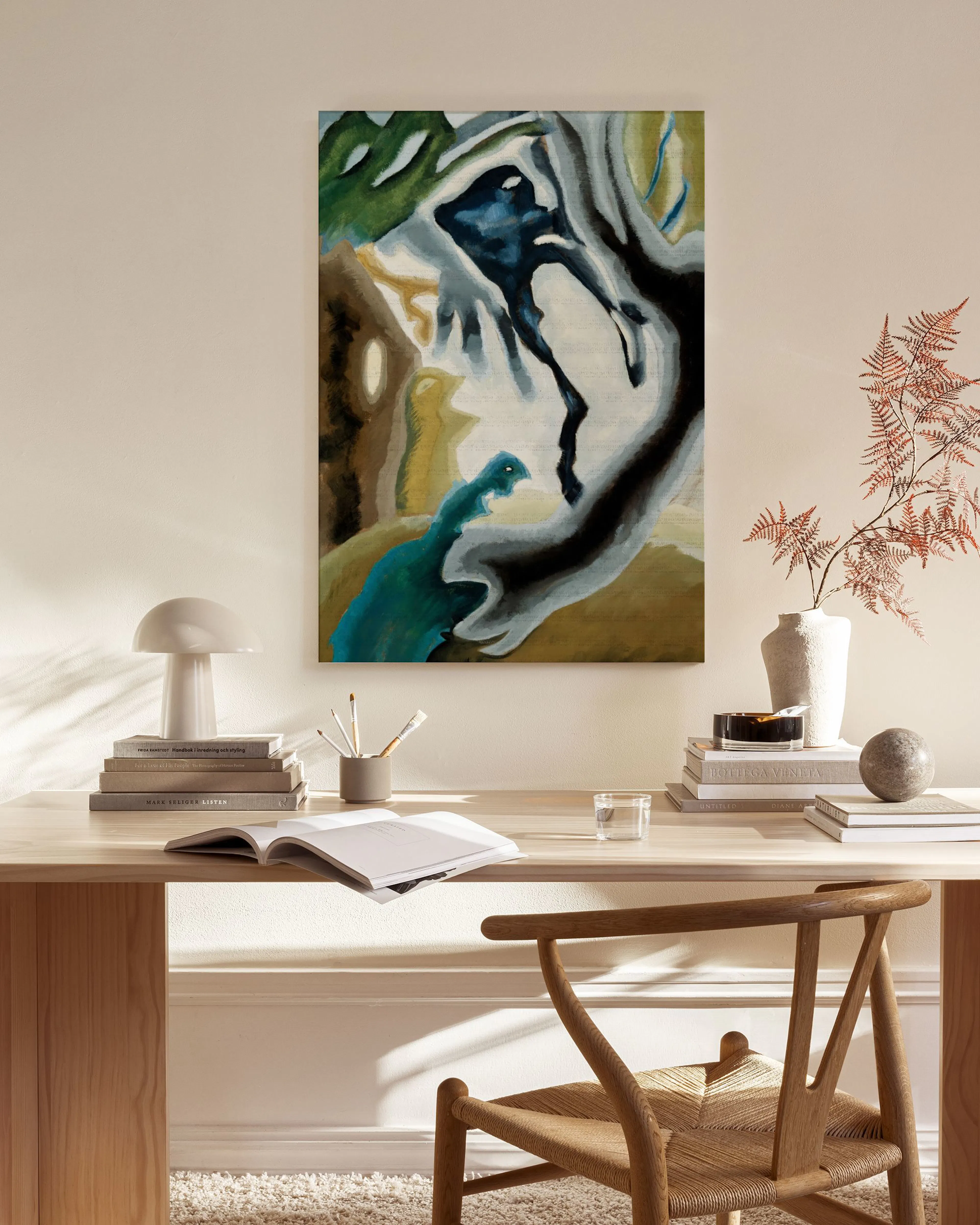 Abstract canvas print with dark blue, teal, and brown organic shapes, hanging in a minimalist living room.