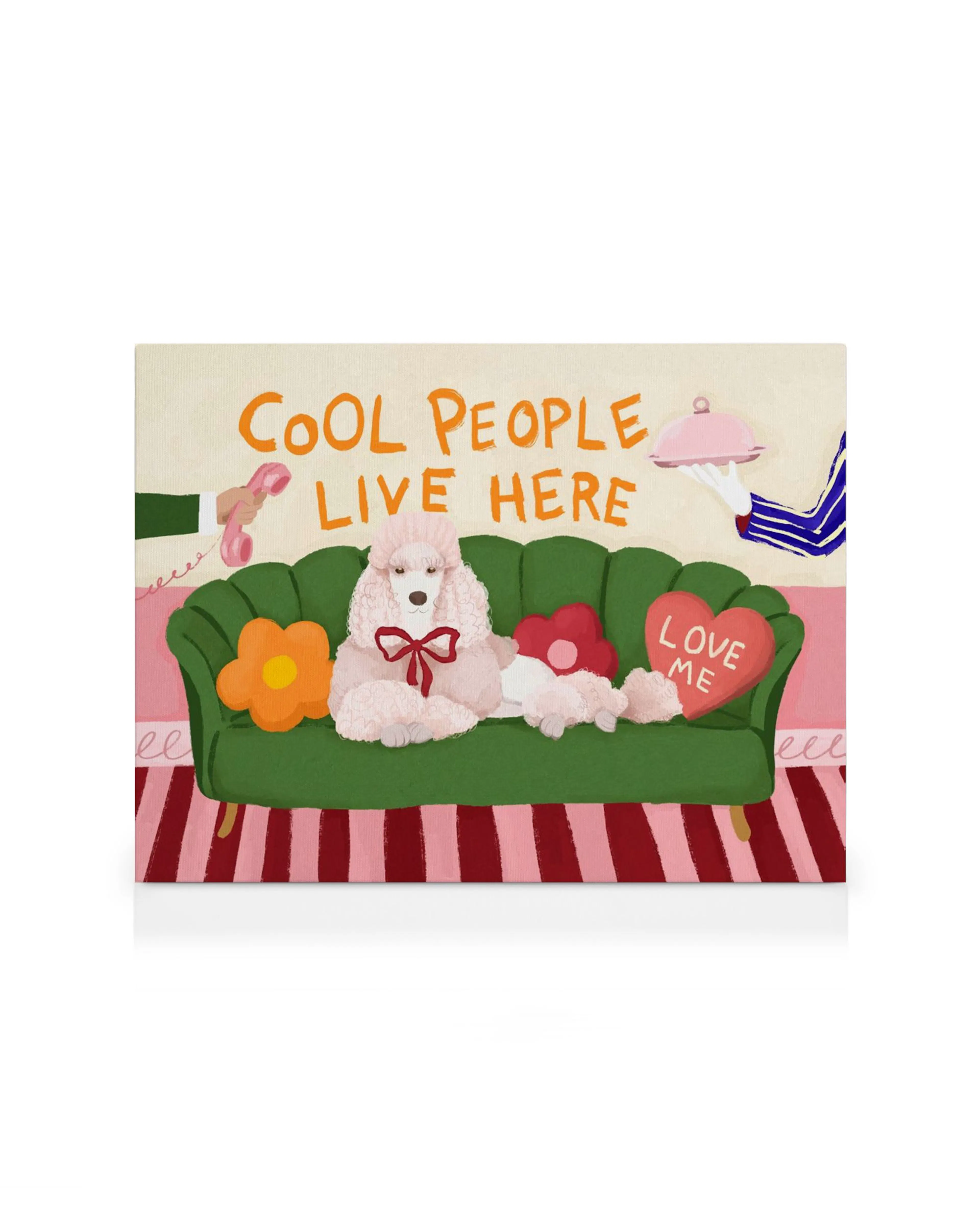 Cool People Live Here canvas print with a fluffy white poodle on a green couch, phone, and heart pillow.