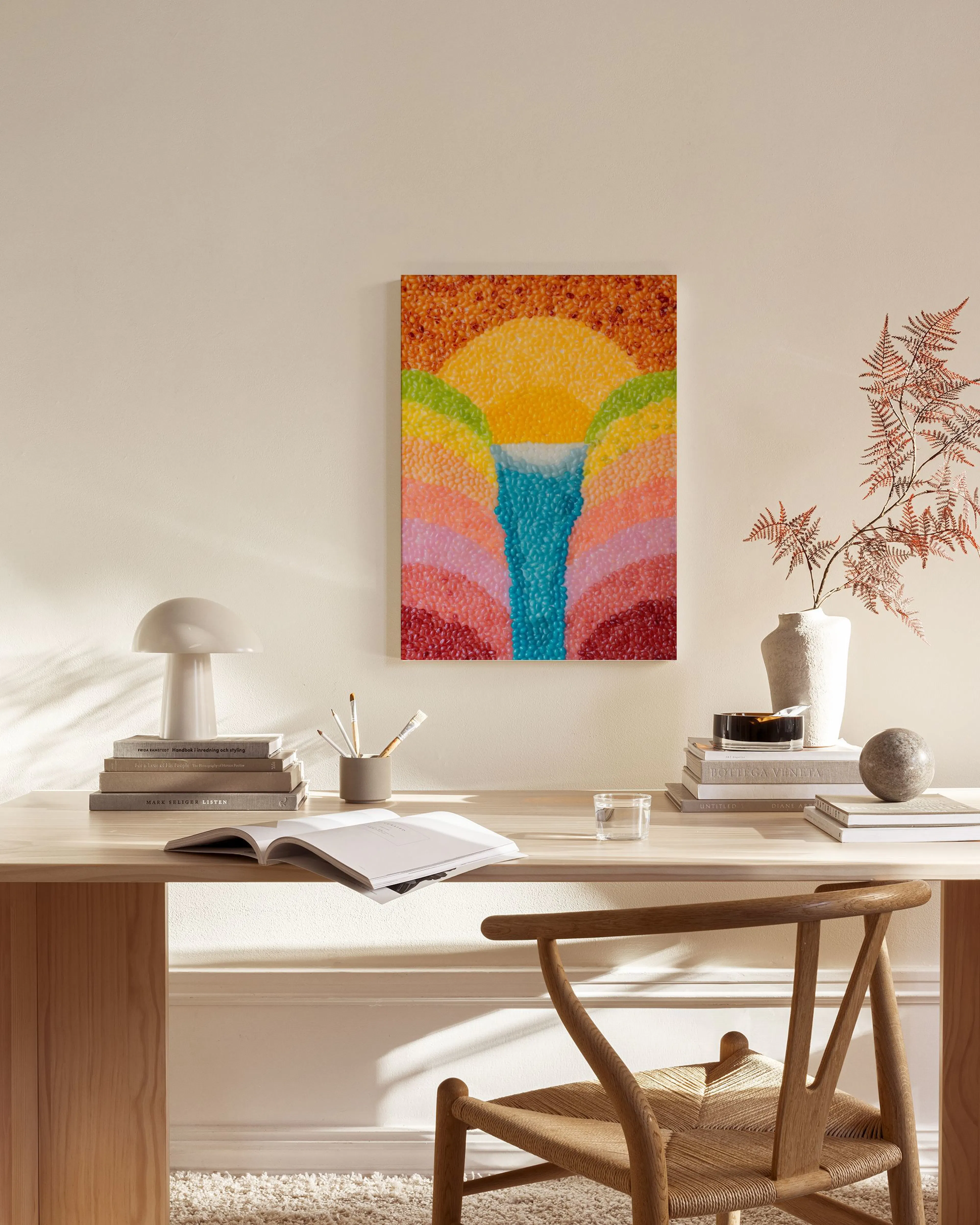 Toile aux couleurs vives représentant un lever de soleil et une cascade, accrochée dans un salon moderne.