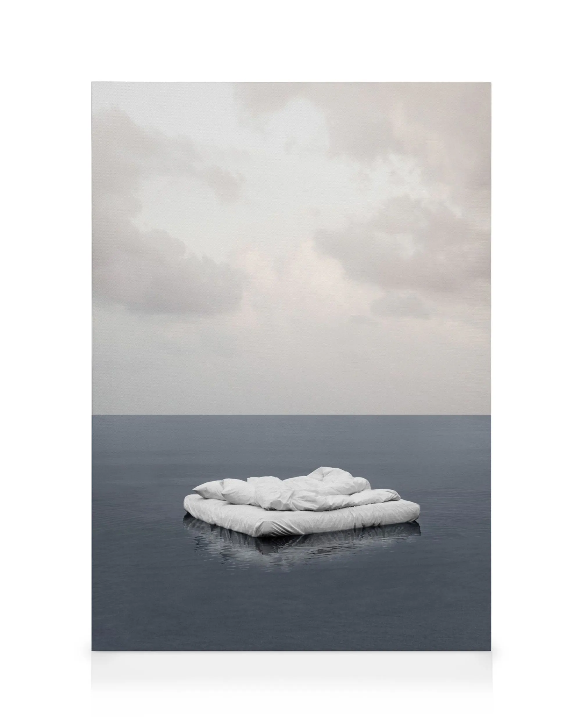 Dreamy canvas print of a woman floating in serene blue and white hues, perfect for bedroom decor.
