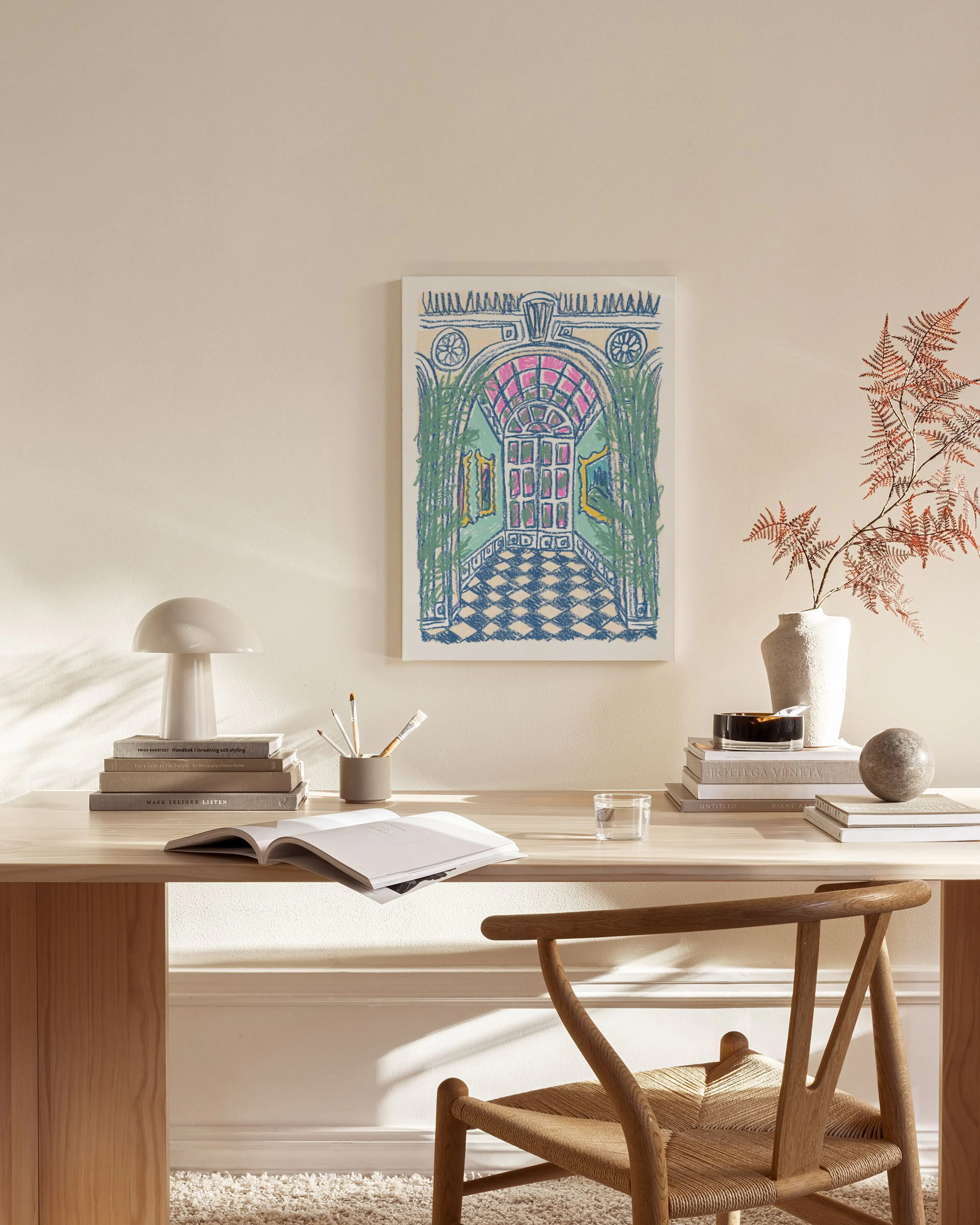 A colorful art print featuring a hallway with a pink arched doorway and blue checkered floor, displayed in a modern living room.