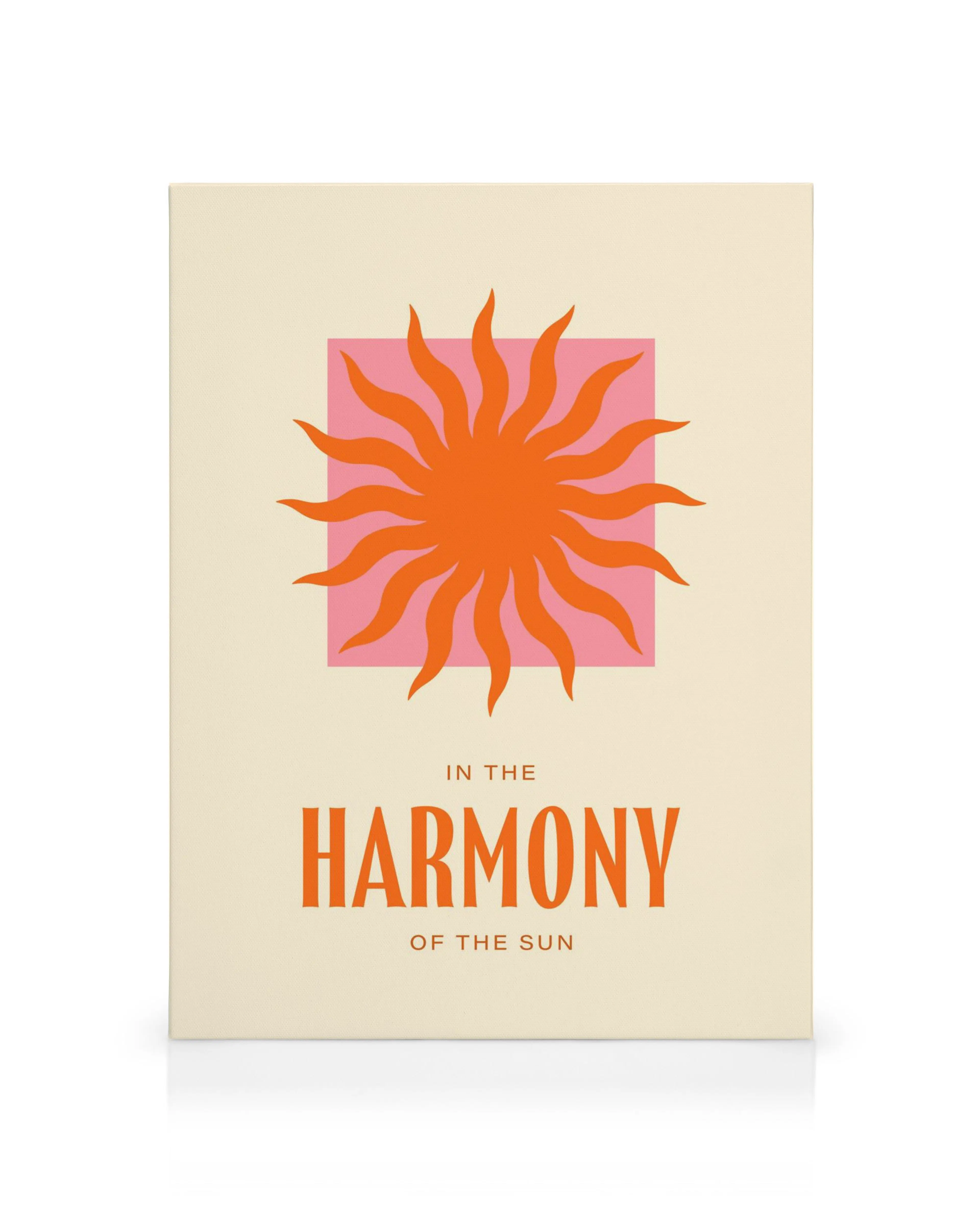 A canvas print with an orange sun on a pink square, and text IN THE HARMONY OF THE SUN on a cream background.