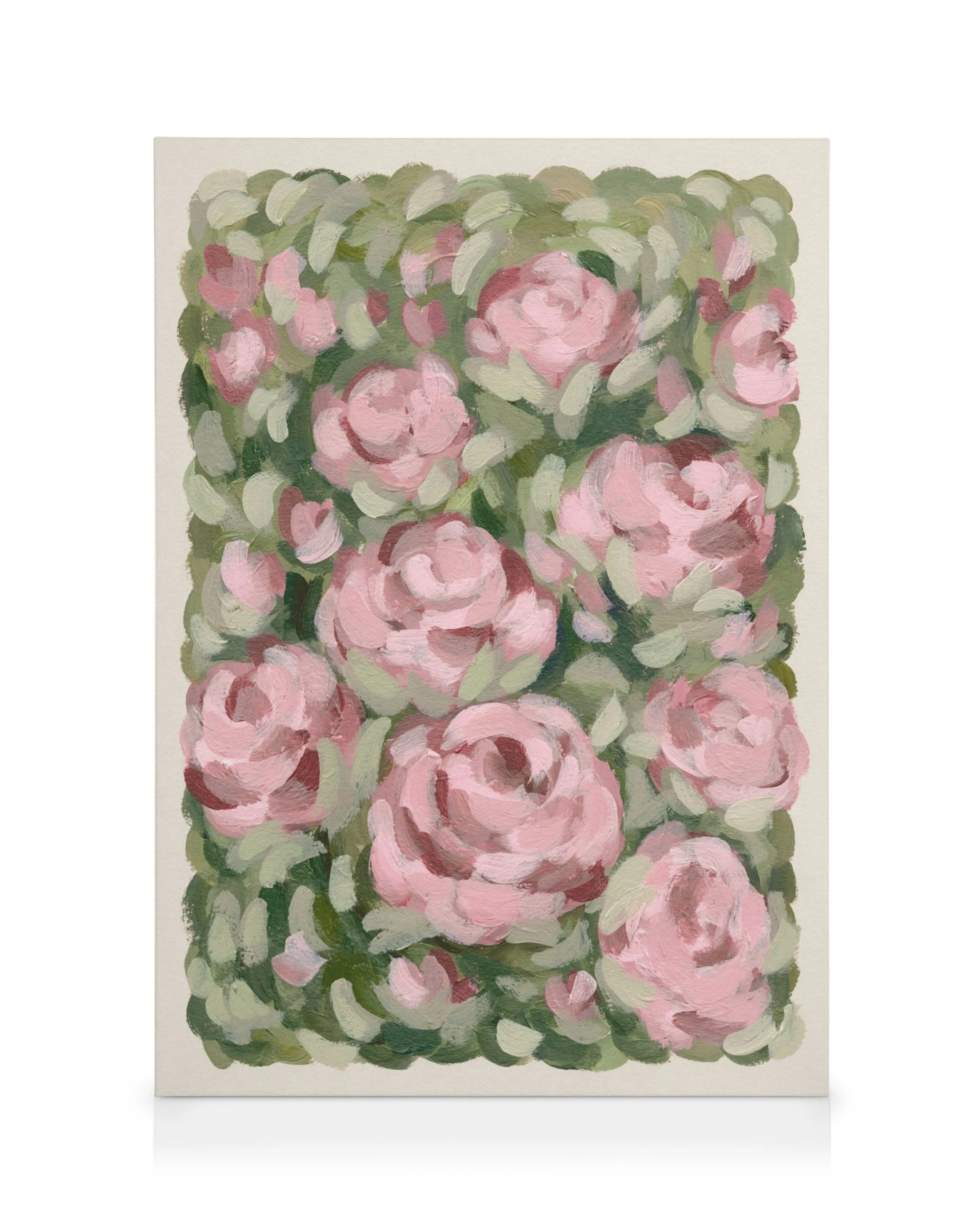 A canvas print featuring a vibrant floral painting of pink roses on a bed of green leaves.