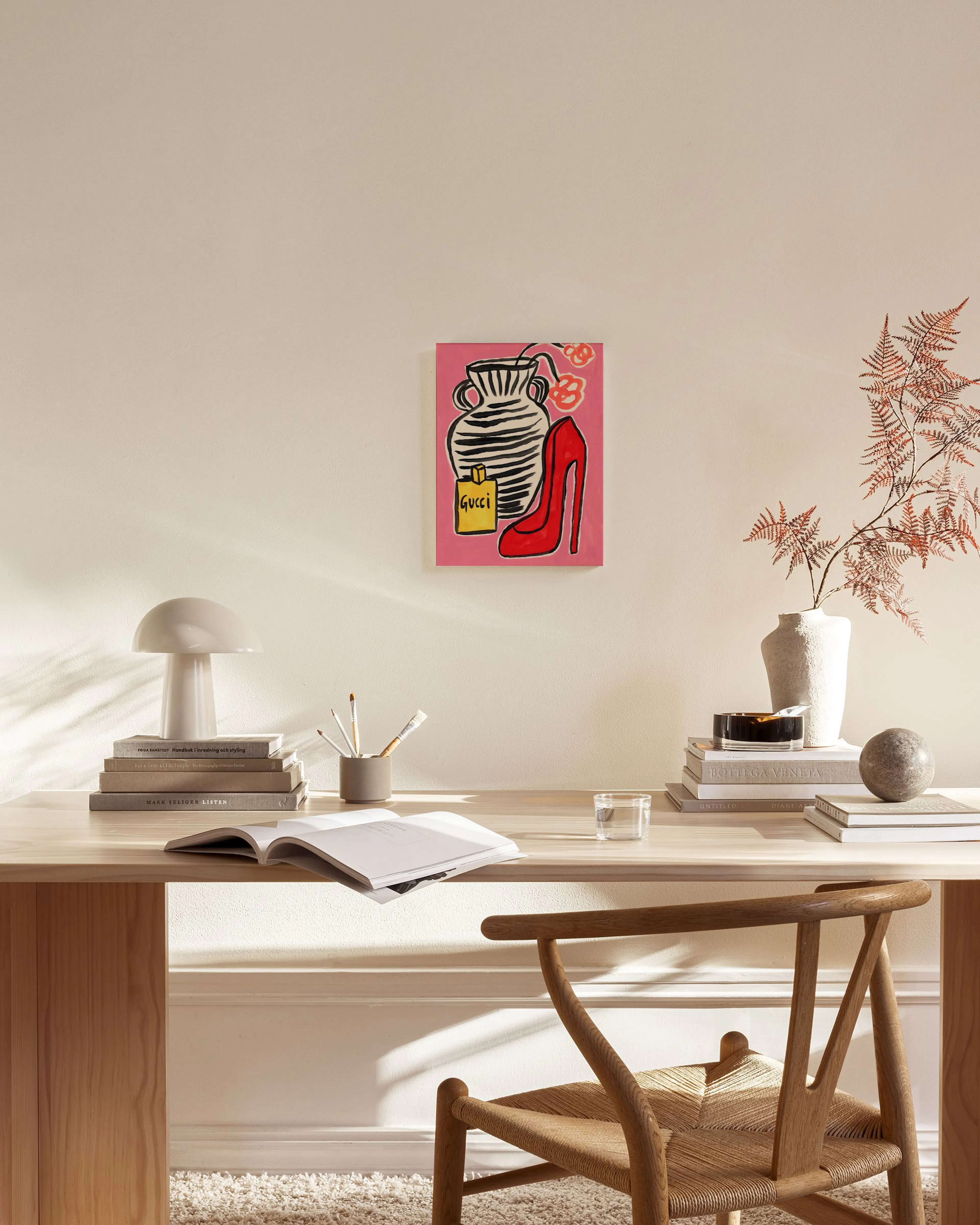 Pop art style print with a black and white striped vase, a red high heel, and a yellow Gucci perfume bottle on a pink background