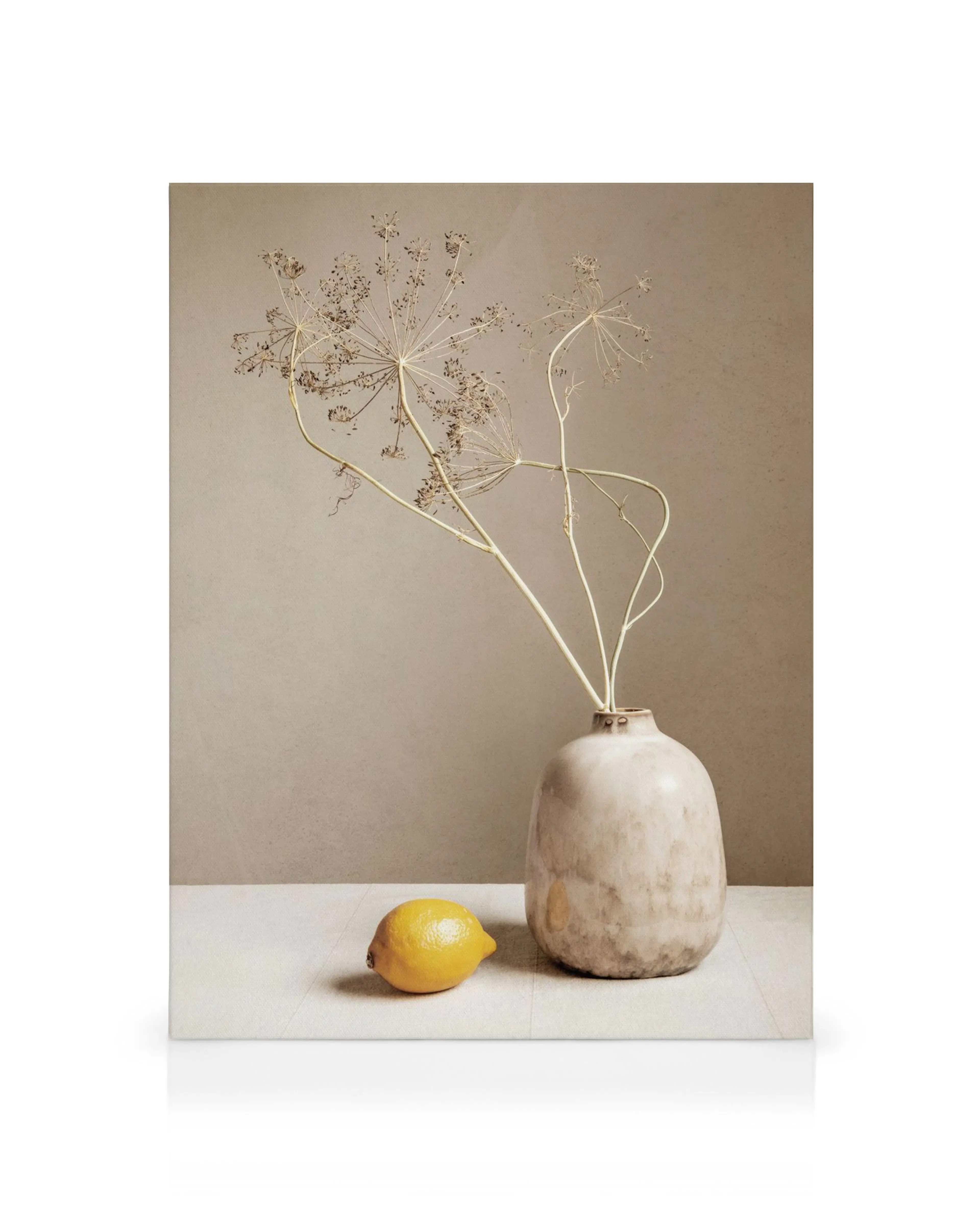 Lærred med brun vase, tørrede planter og gul citron på beige baggrund. Minimalistisk, jordnært fotokunst.
