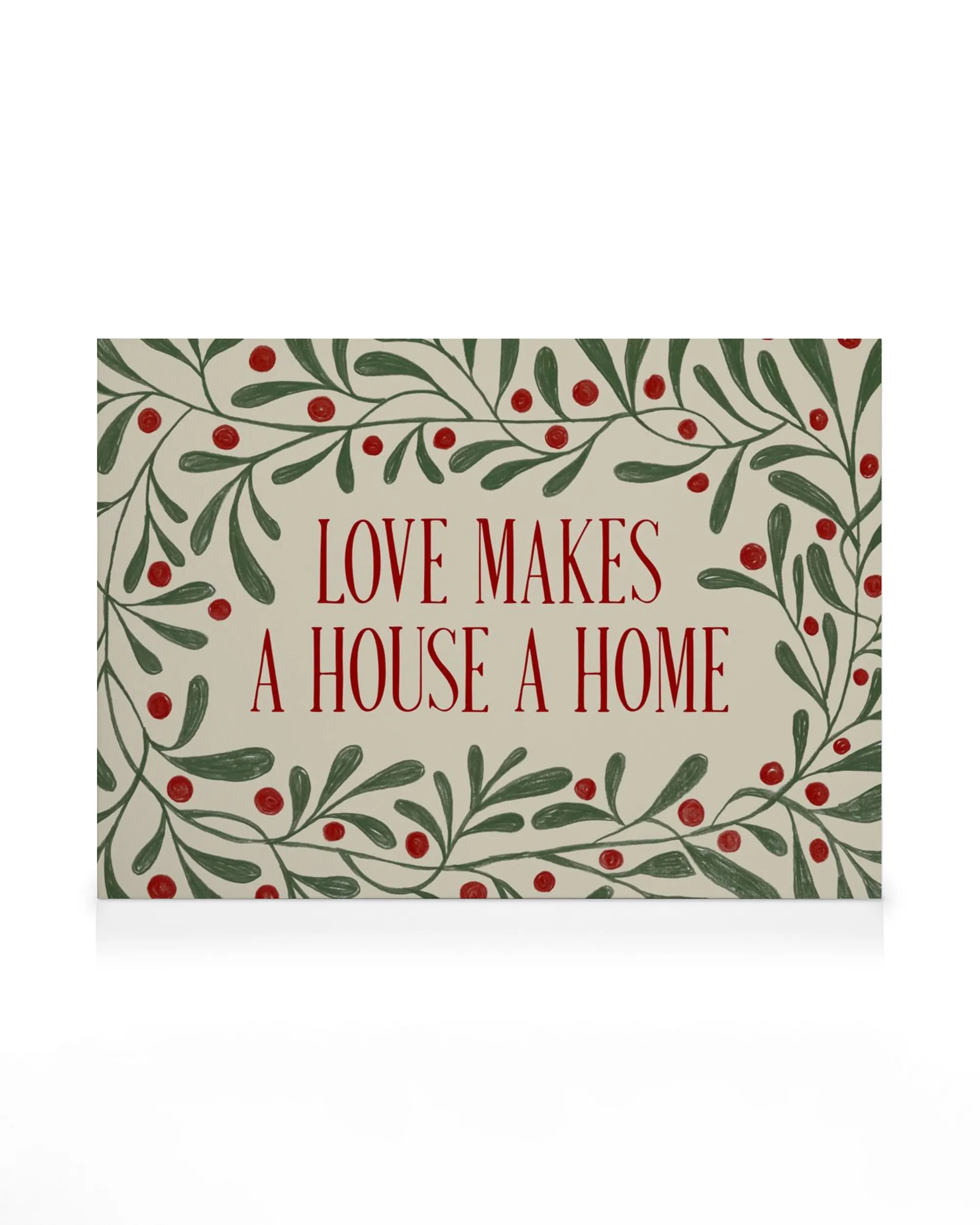 Stampa su tela con cornice di foglie e bacche rosse, frase LOVE MAKES A HOUSE A HOME al centro.