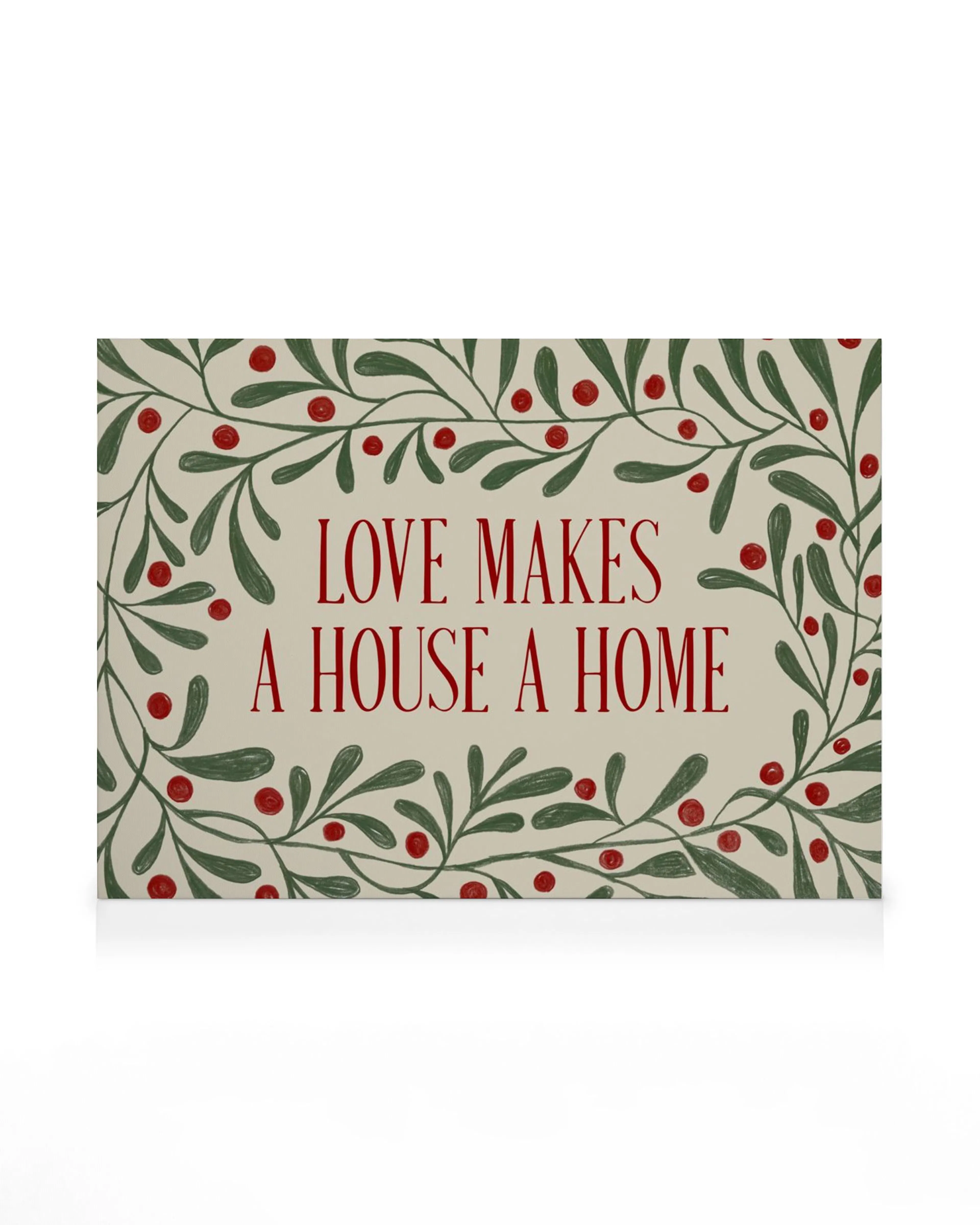 Stampa su tela con cornice di foglie e bacche rosse, frase LOVE MAKES A HOUSE A HOME al centro.
