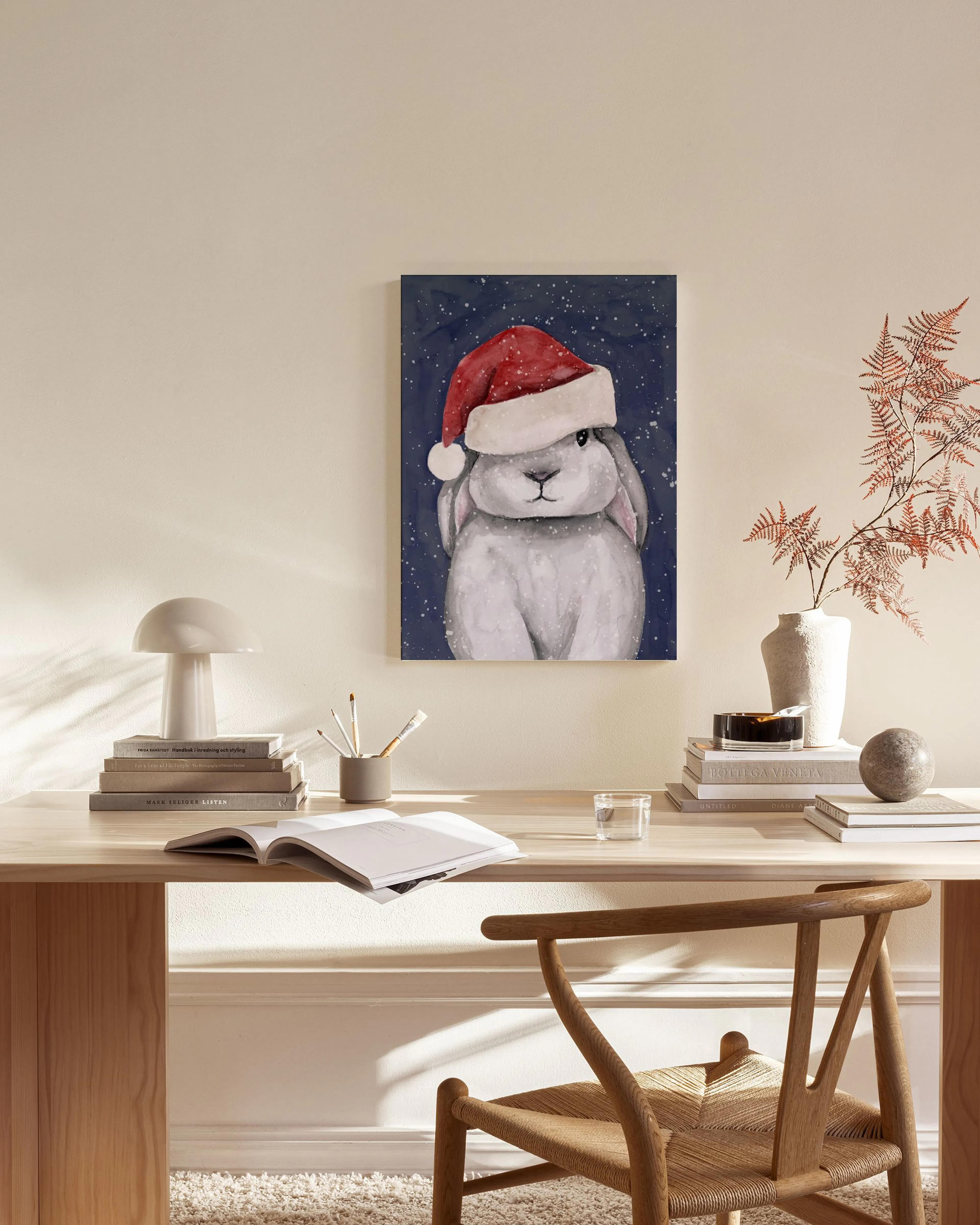 Canvas print of a fluffy grey Christmas bunny wearing a Santa hat, displayed in a modern living room.