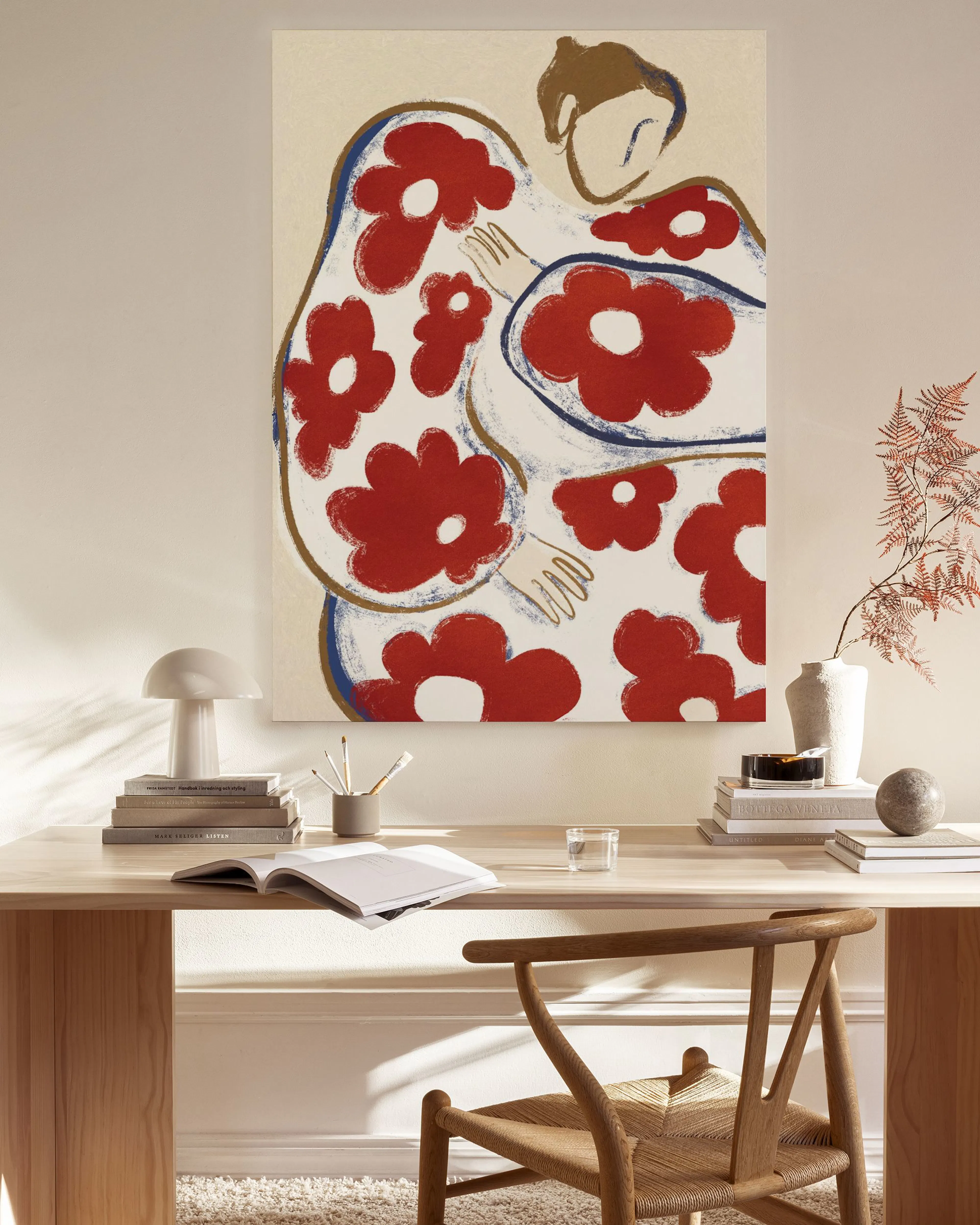 Abstract canvas print of two figures embracing, with red and white floral patterns, in a modern living room.