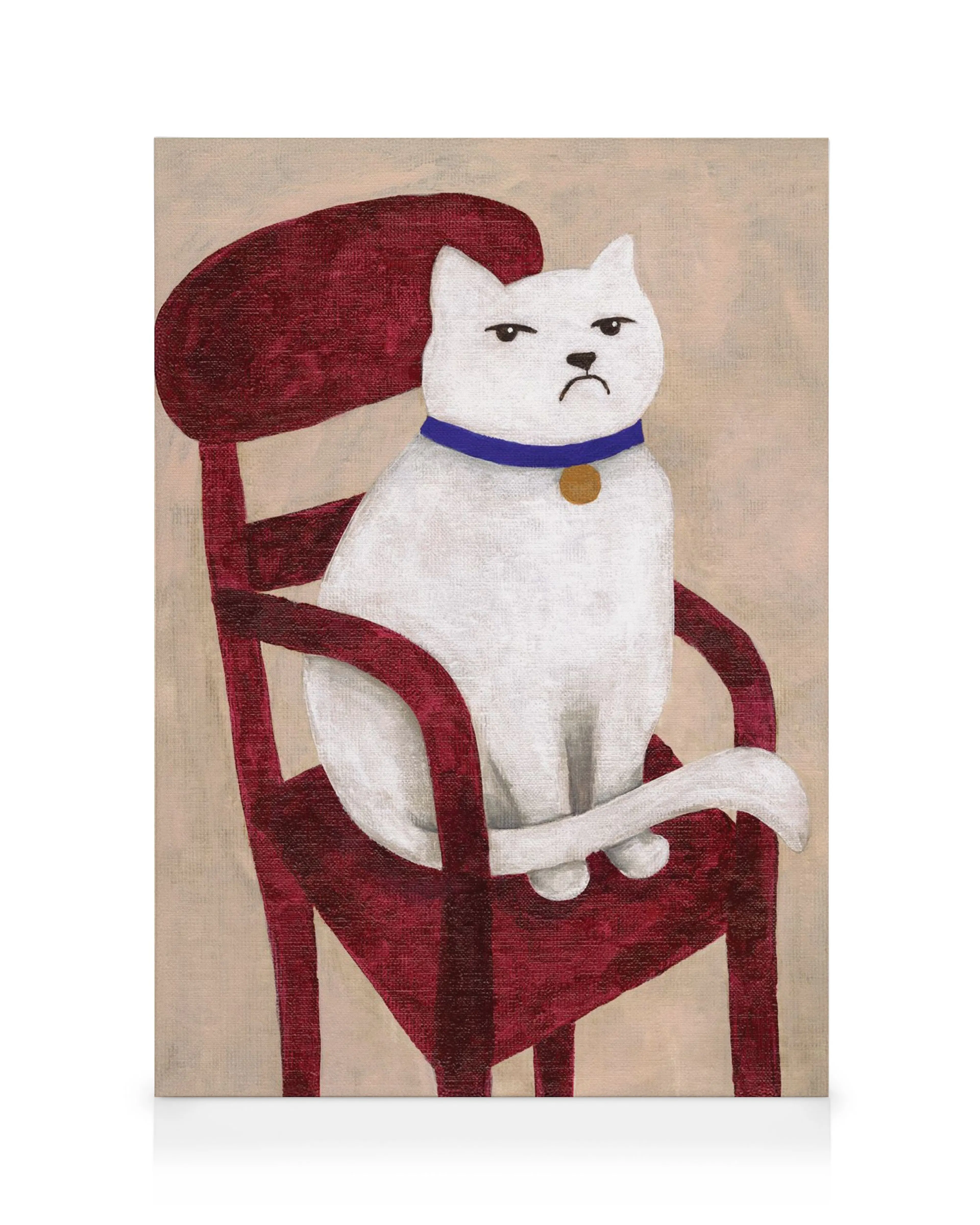 A canvas print featuring a grumpy white cat with a blue collar sitting on a red chair.