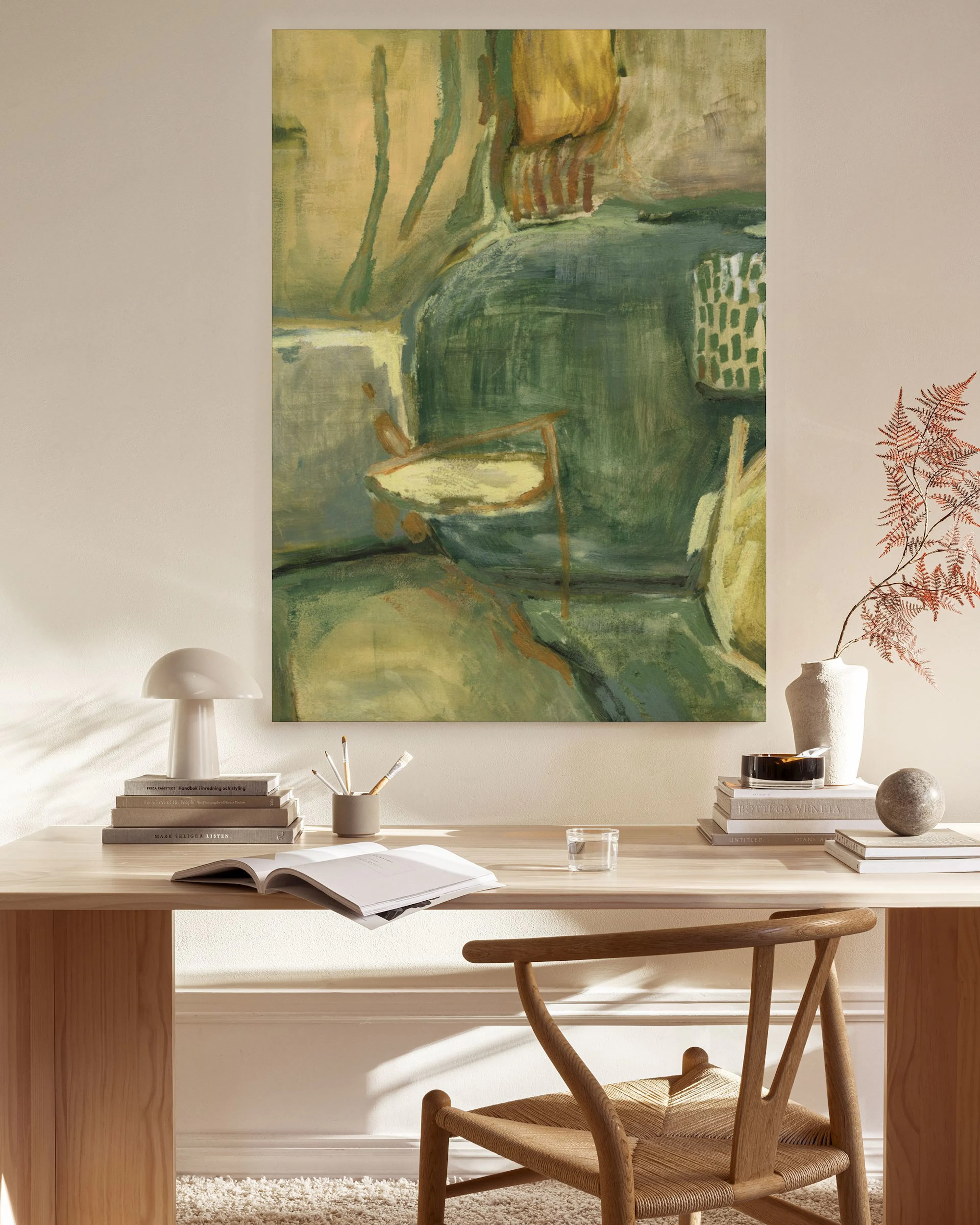Abstract canvas print with green, olive, and ochre hues, featuring subtle geometric patterns, displayed in a modern living room.