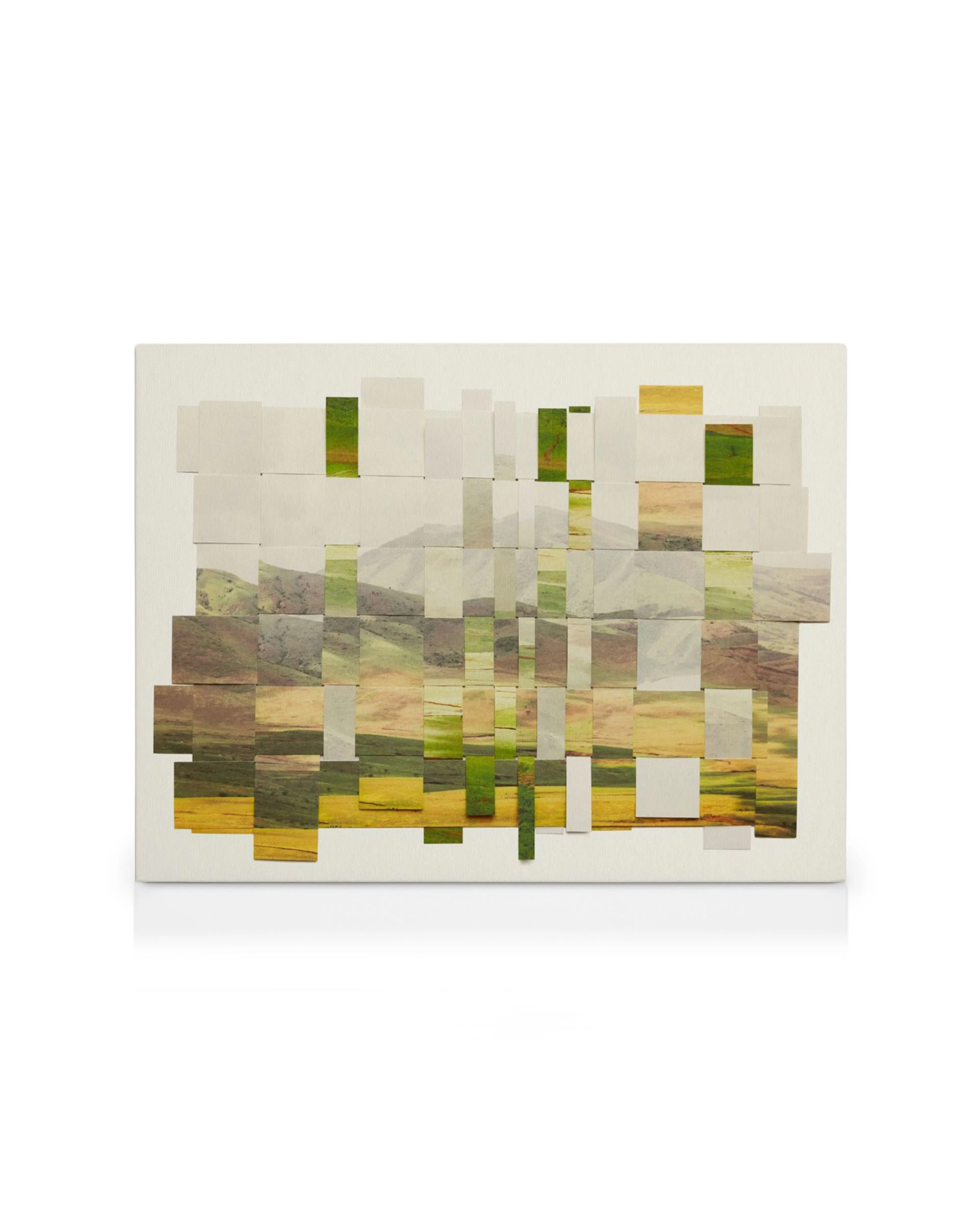A canvas print featuring a landscape with green and yellow fields under mountains, composed of overlapping strips.
