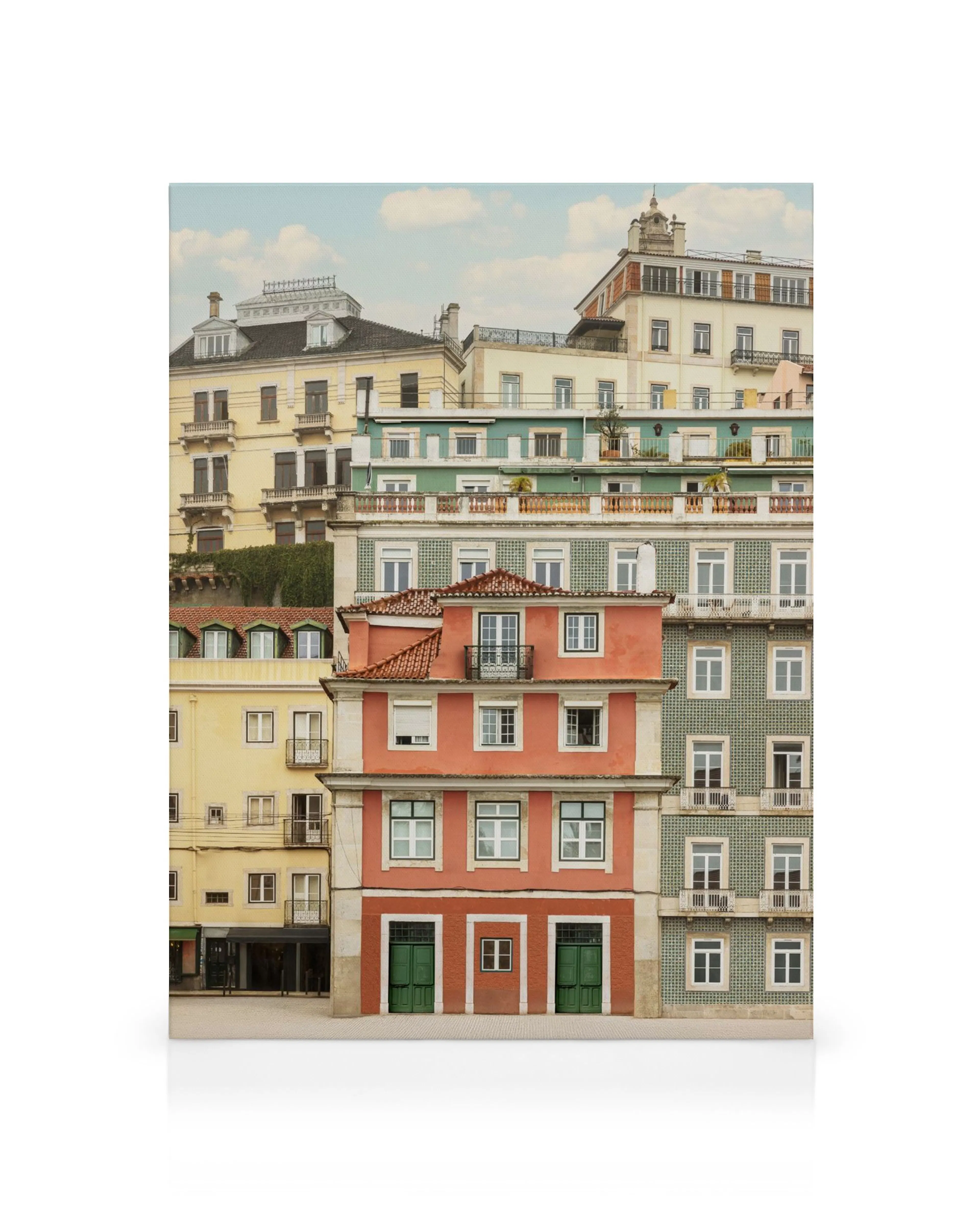 A canvas print featuring stacked colorful buildings with a prominent red building in the foreground and green doors.