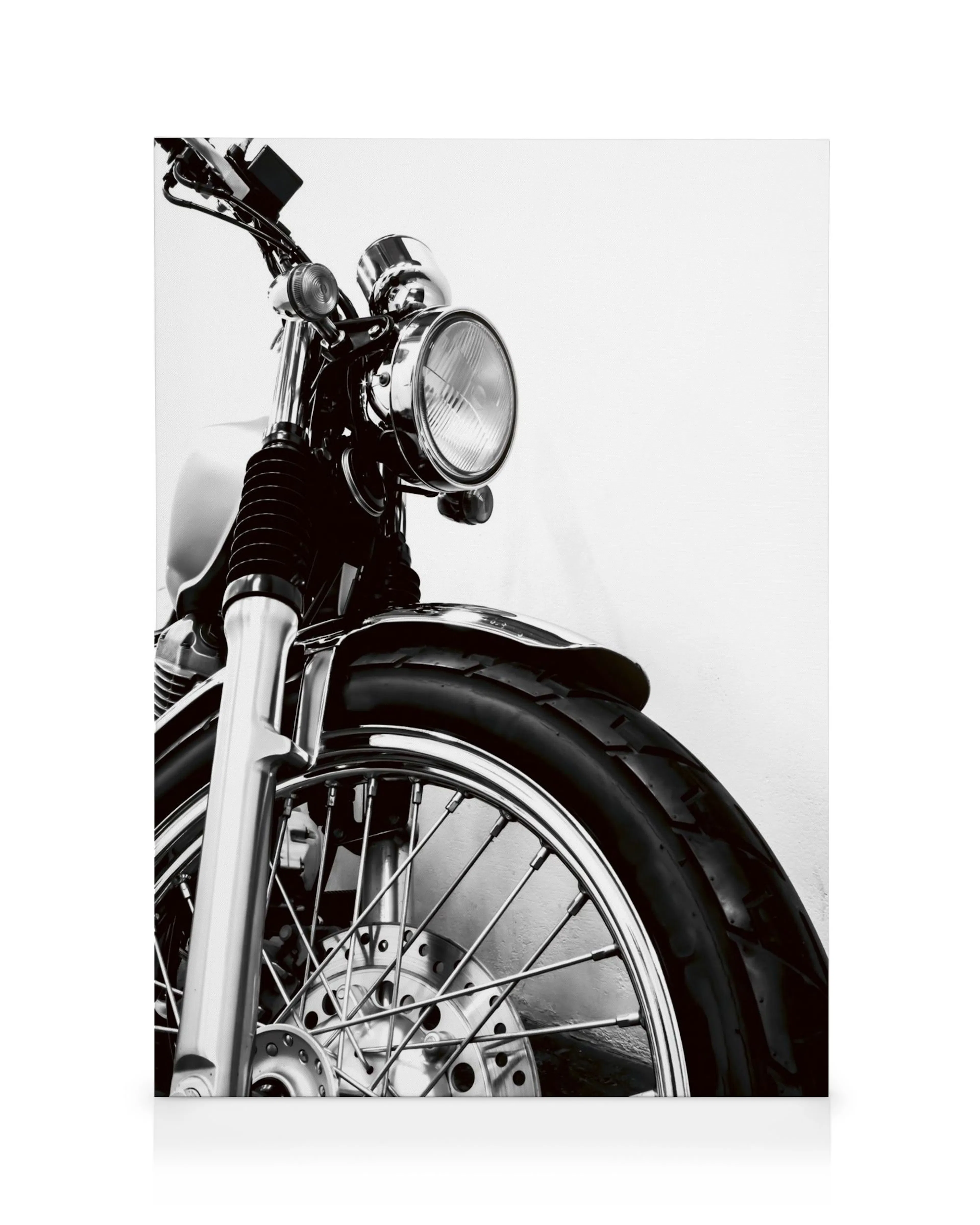 Stampa tela monocromatica di una moto classica con dettagli cromati, ruota e faro in primo piano.