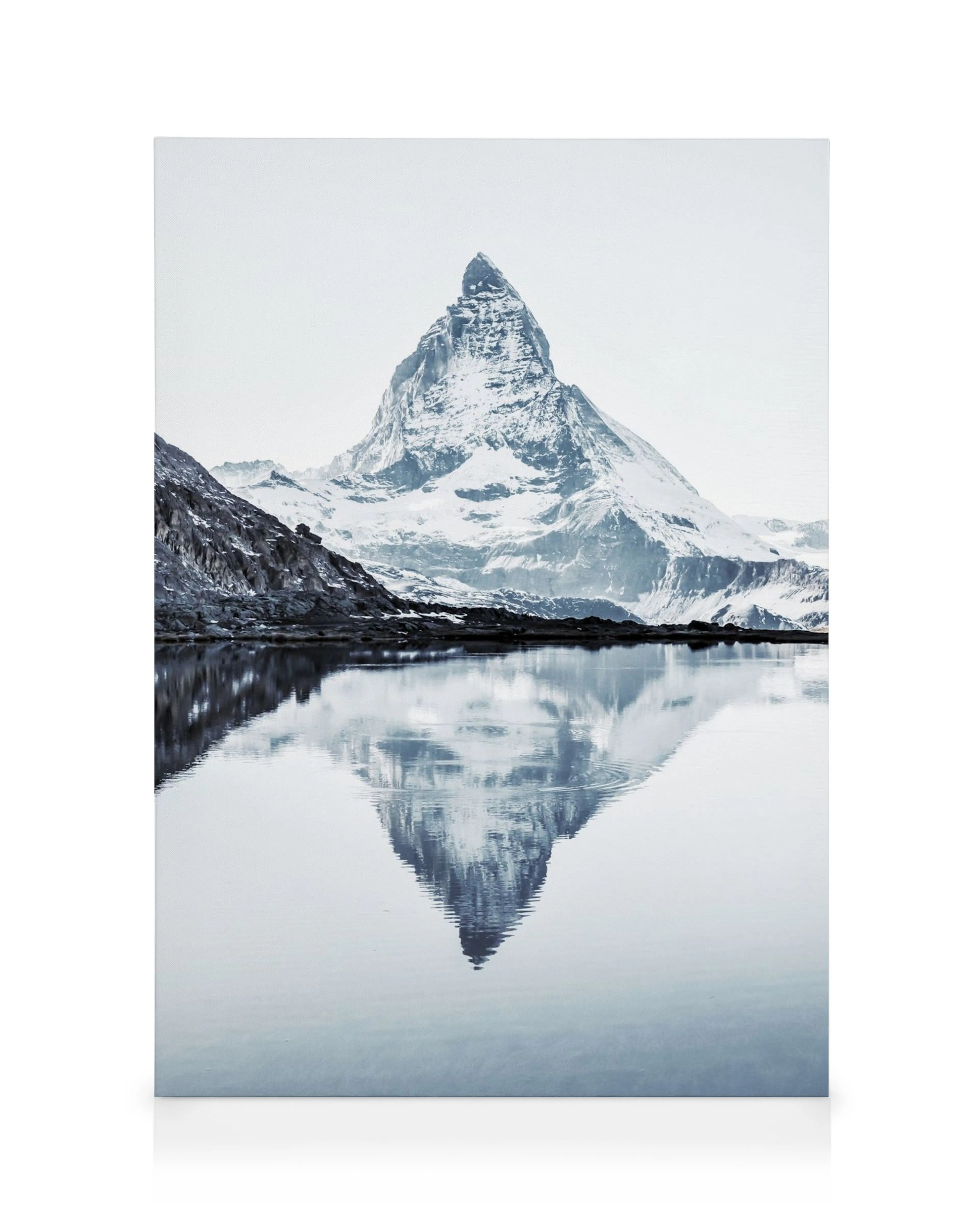 Matterhorn mountain reflected in still lake water, black and white canvas print with snowy peaks.