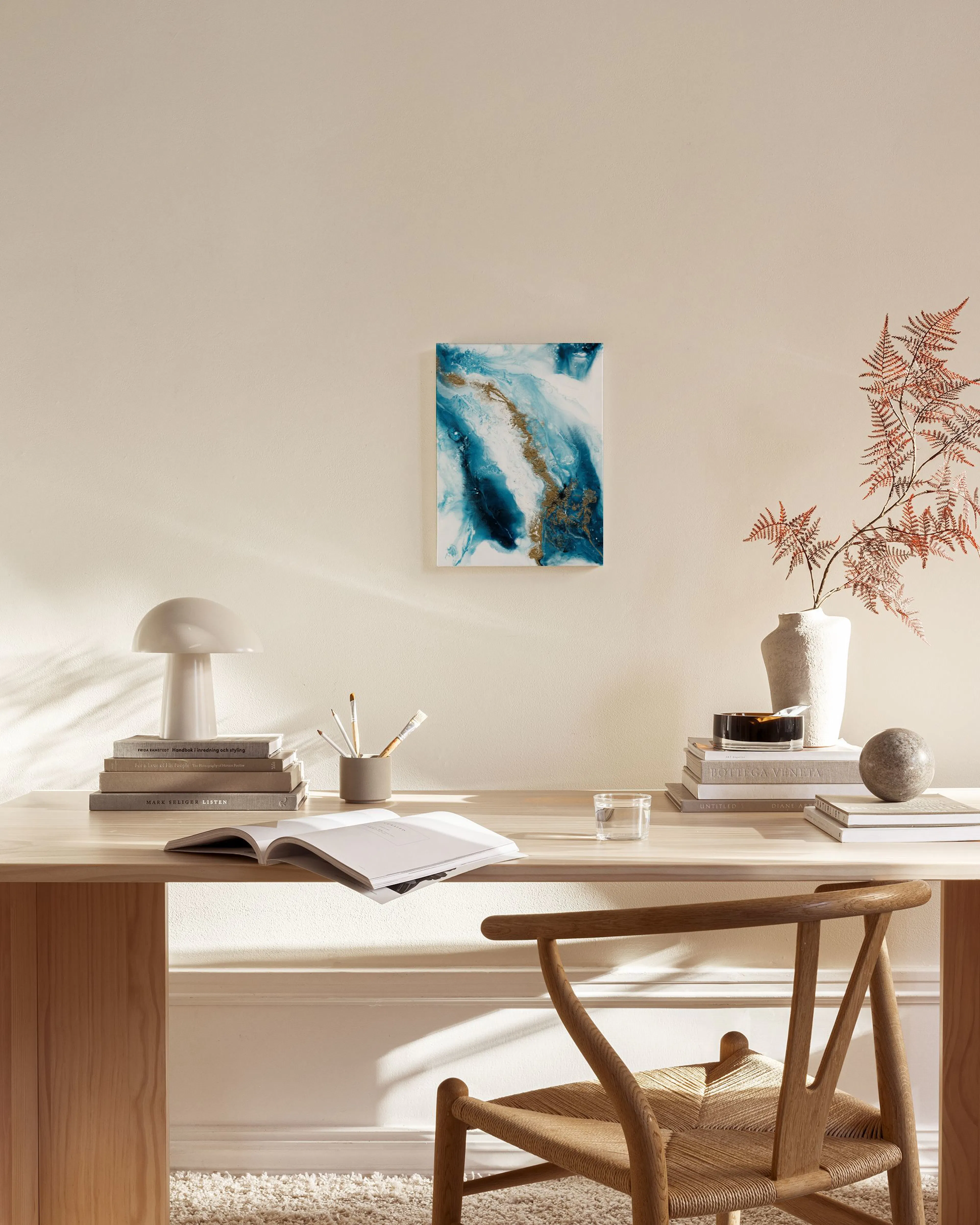 Abstract canvas print with white, deep blue, and light blue fluid shapes, highlighted by metallic gold streaks.
